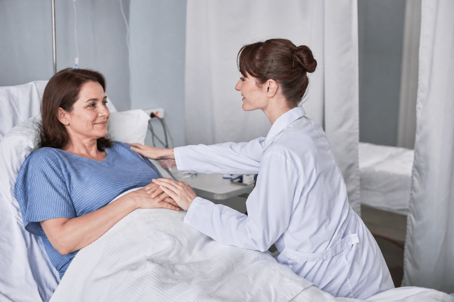 patient speaking with healthcare professional during hospital recovery