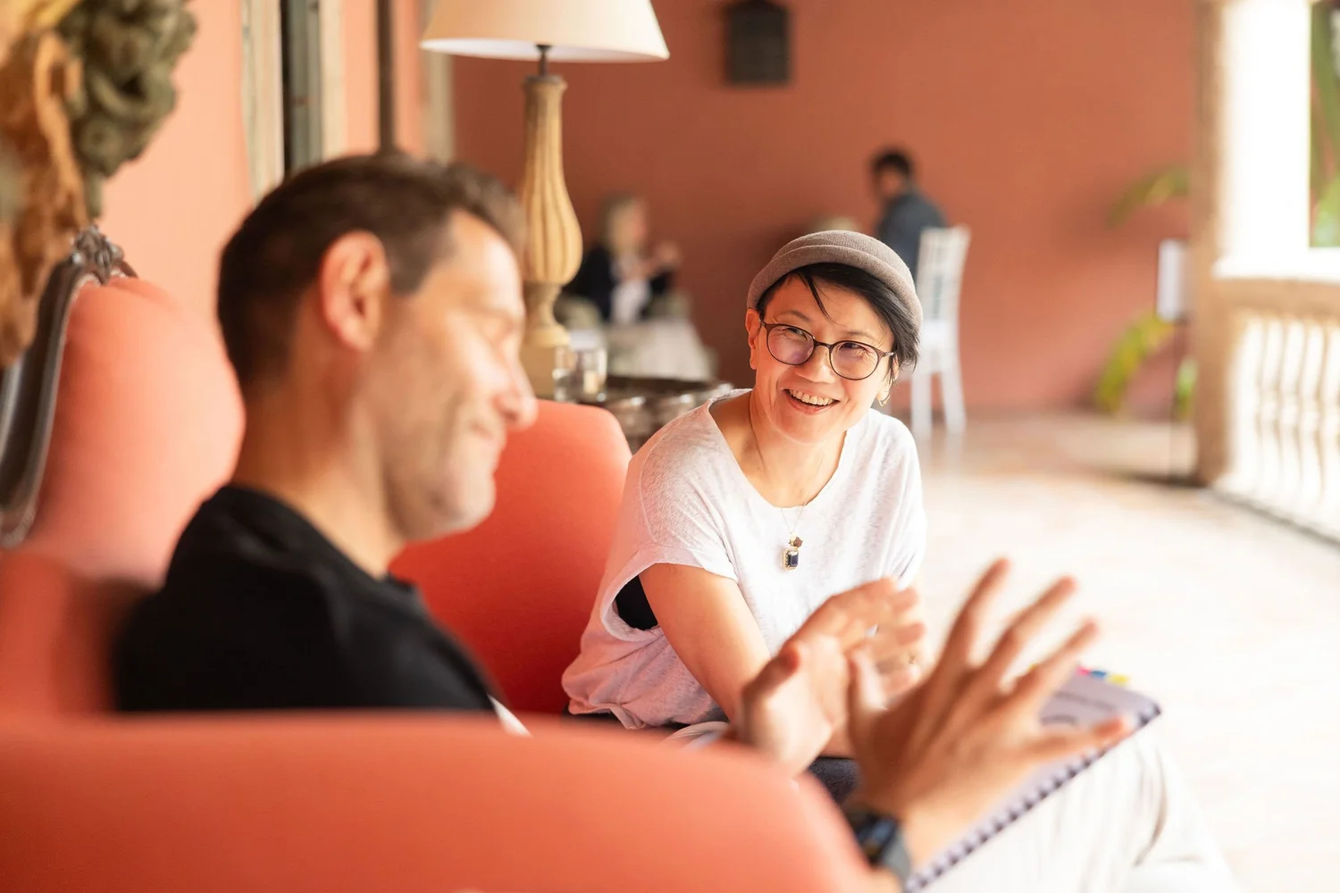 Two Gold Mind coaches smiling mid-conversation during a coaching session