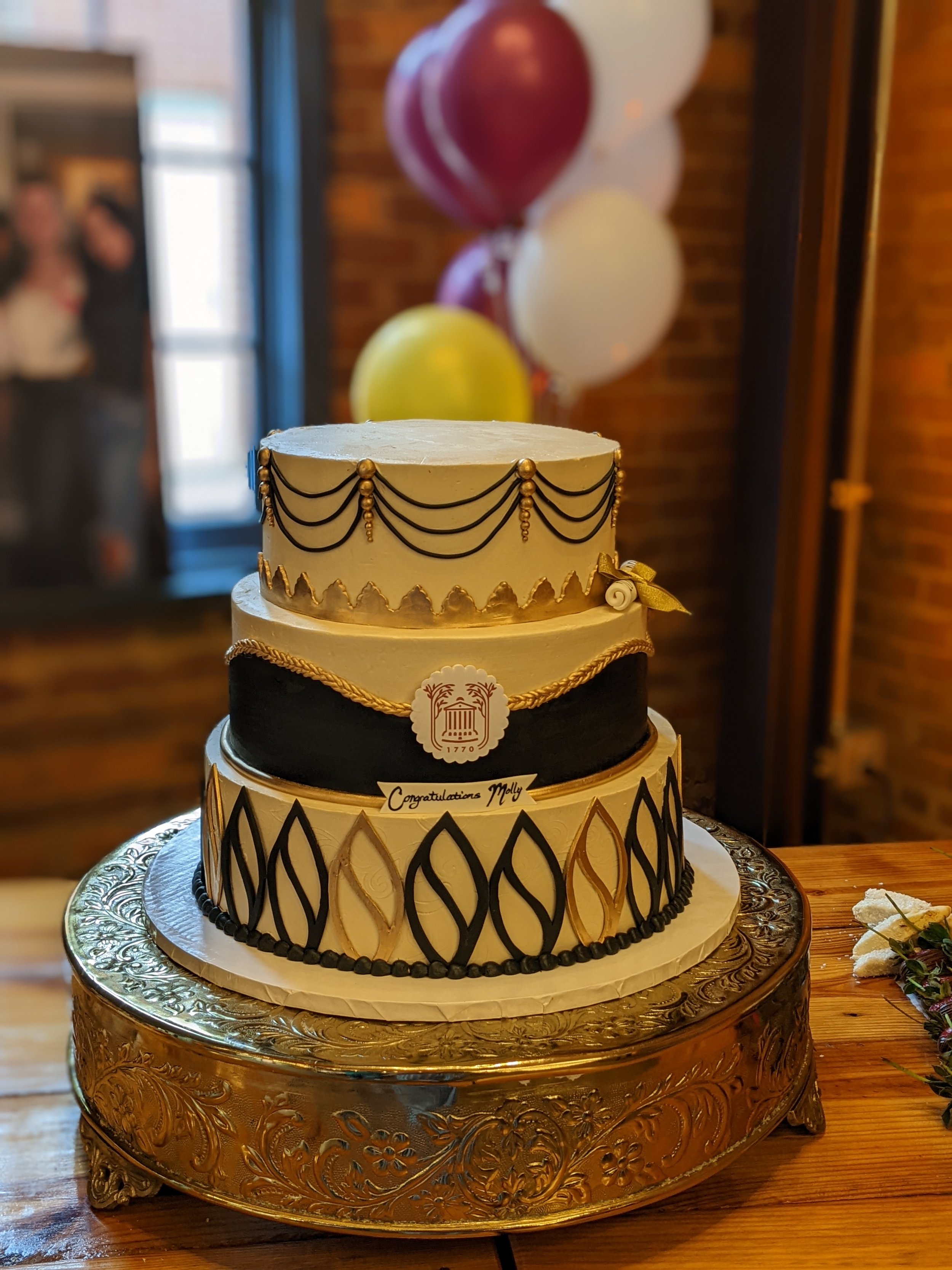 Elegant black and gold graduation cake