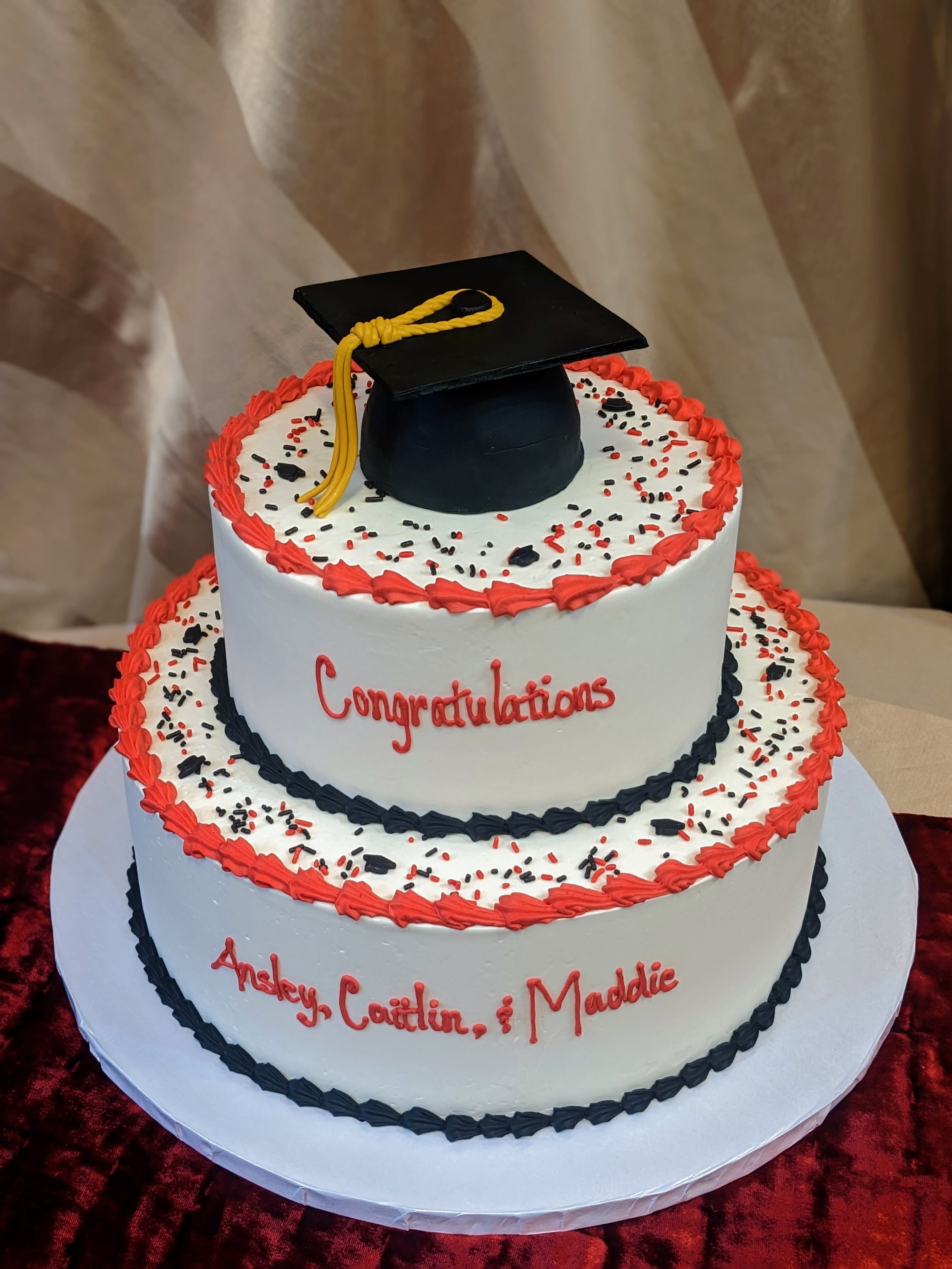 Simple black and red cake with grad cap