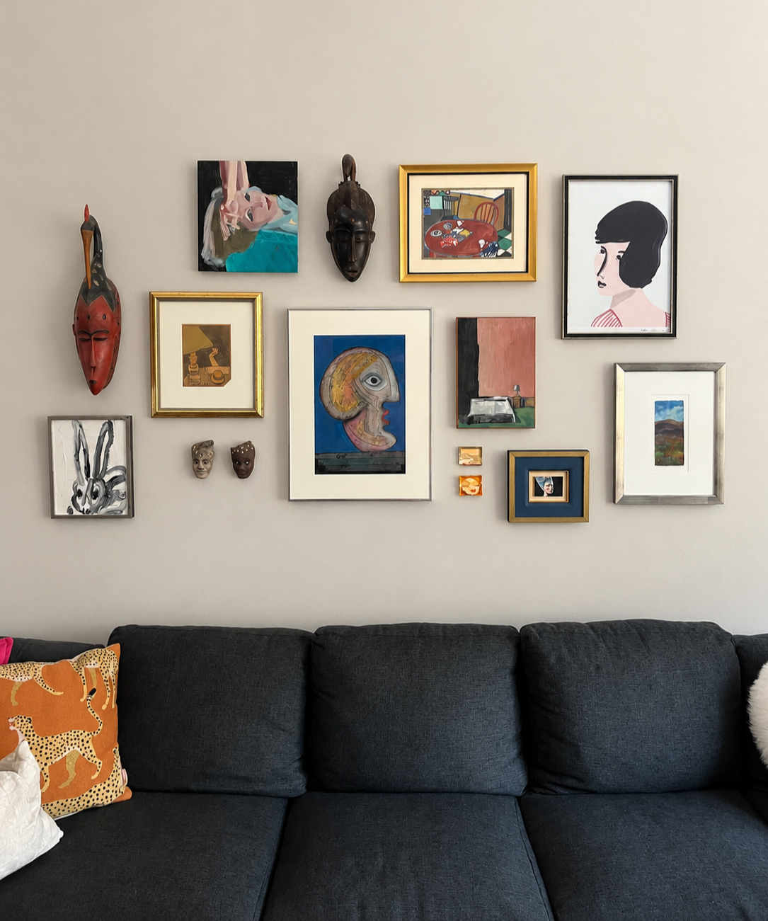 Salon wall of artwork showing varying frames