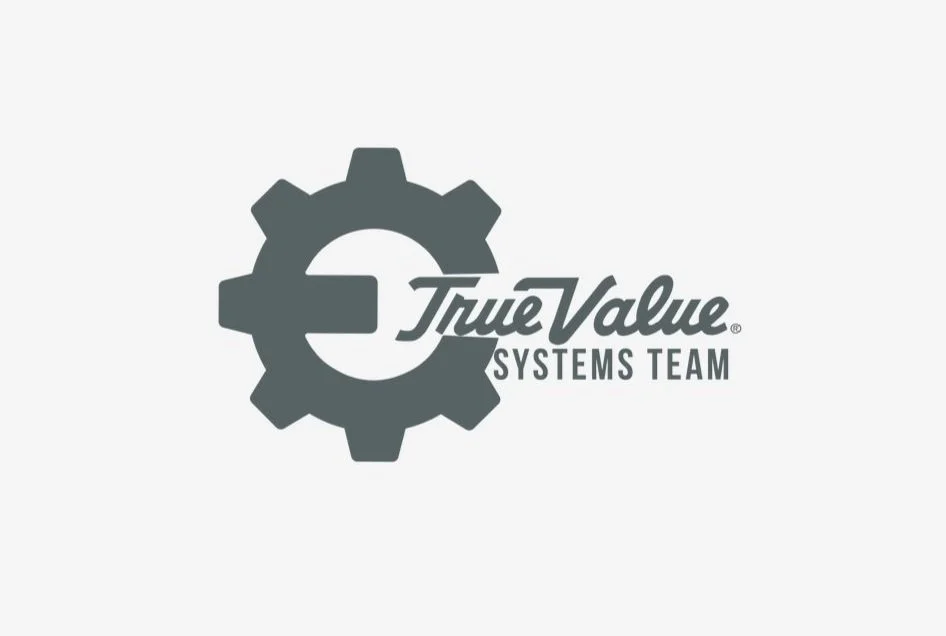 Gray gear with the words "True Value Systems Team" inside and next to it.