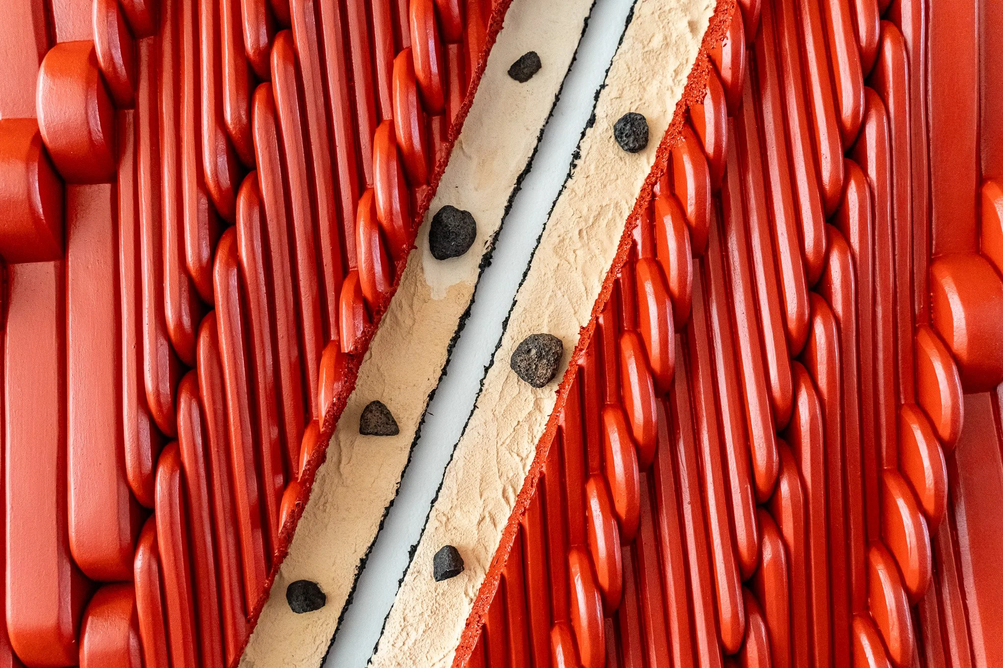 Amanda Martínez, Armazón, 2023–24 (detail). Wood, polystyrene foam, lava rock, pigmented stucco (portland cement, sand, lime, water, natural iron oxide pigment), galvanized steel lathe, roofing tar paper, sand, shredded tire rubber, acrylic polymer, 