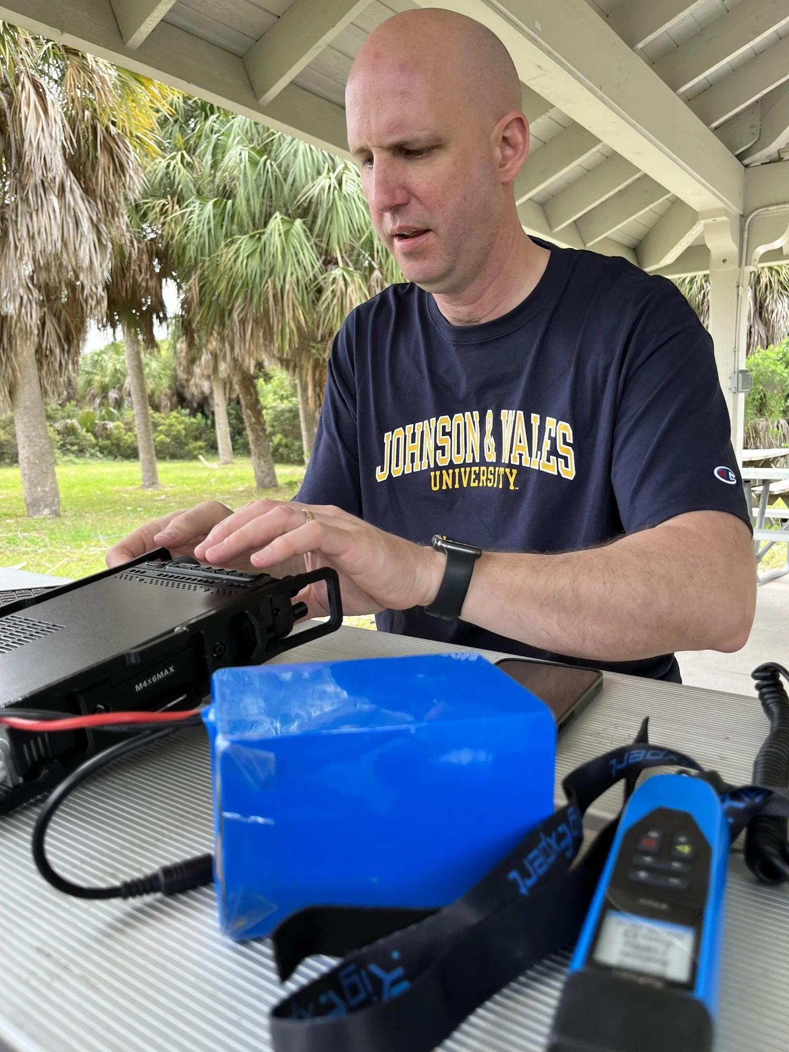 N1JUR operating ham radio outdoors with laptop and field gear
