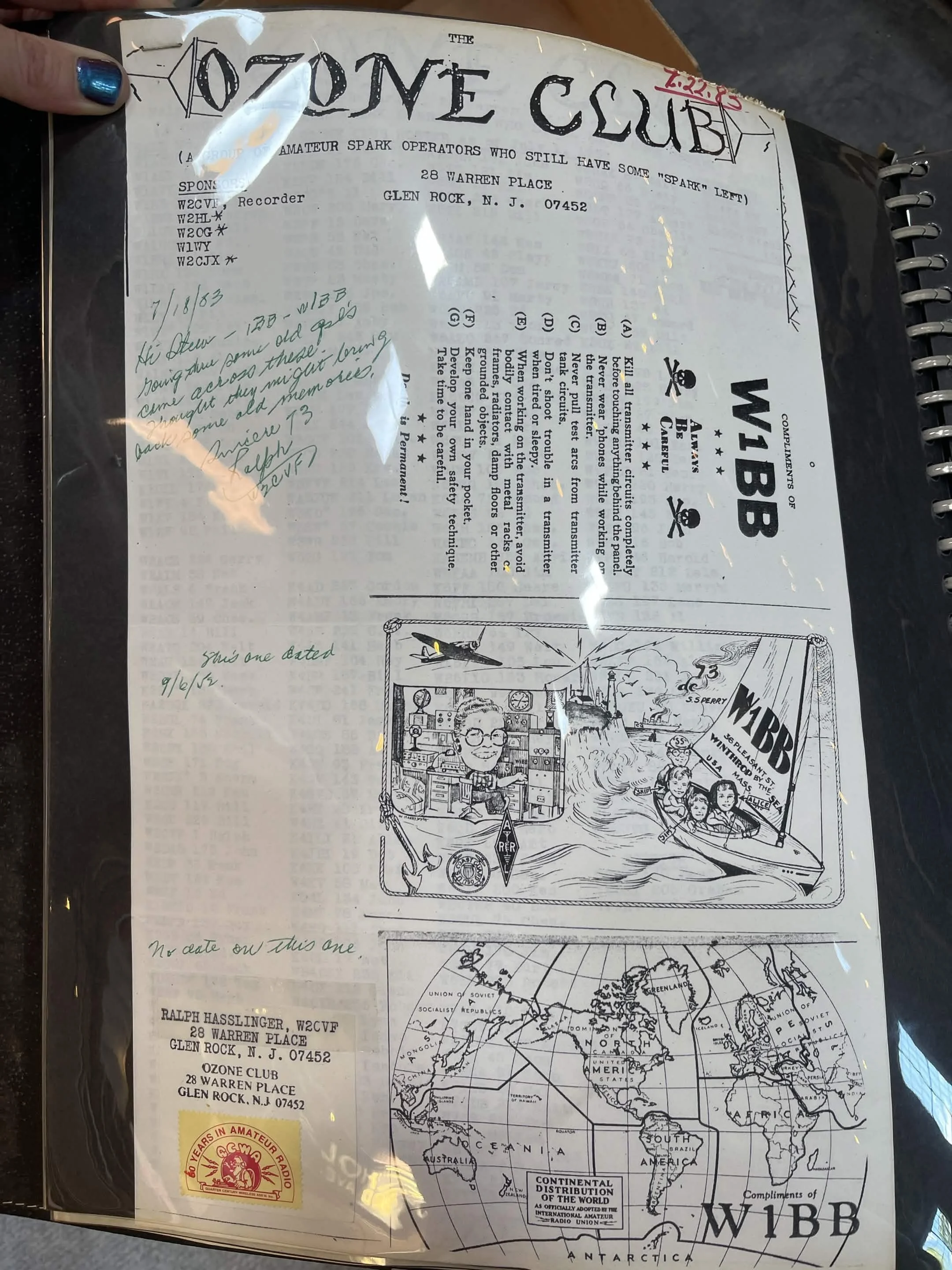 A vintage magazine page or printed sheet related to a radio amateur club, featuring a map of the world, handwritten notes, and a cartoon illustration of people on a boat, with captions and technical information about radio and amateur radio clubs.