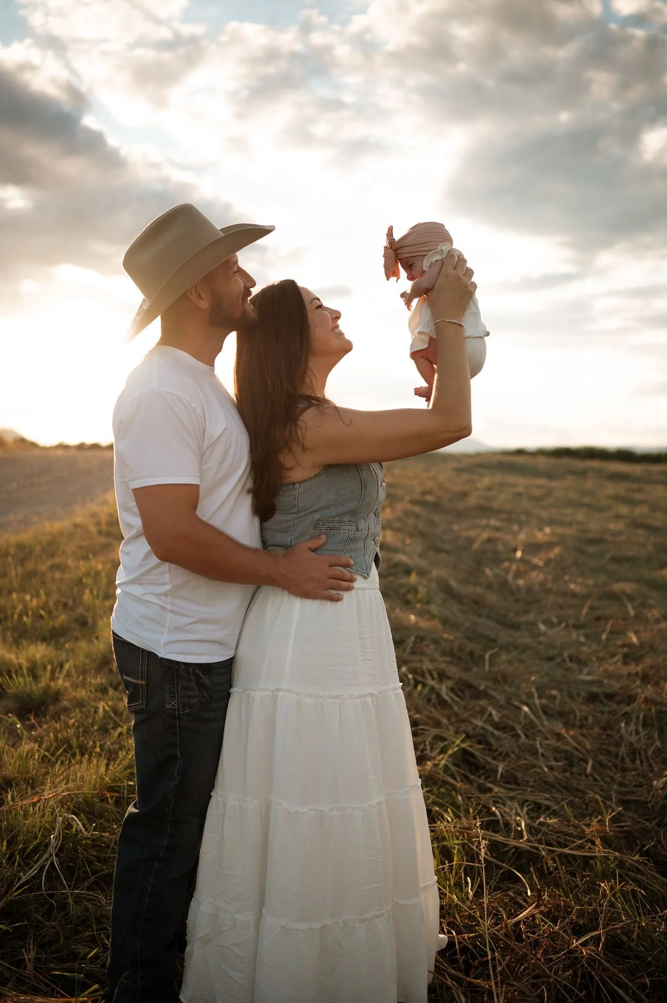 Mom holding baby while mom and dad smile