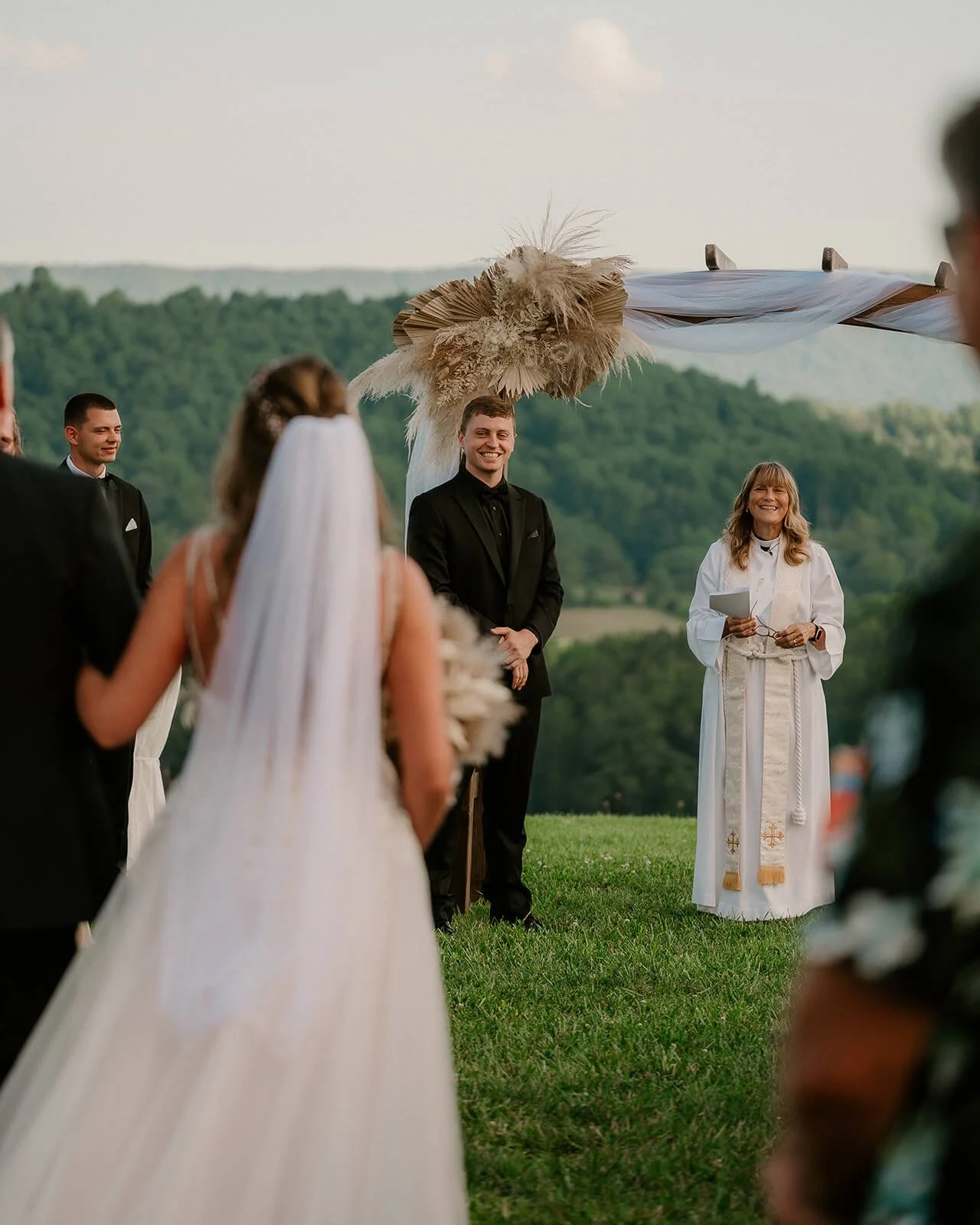 groom watching bride come down isle