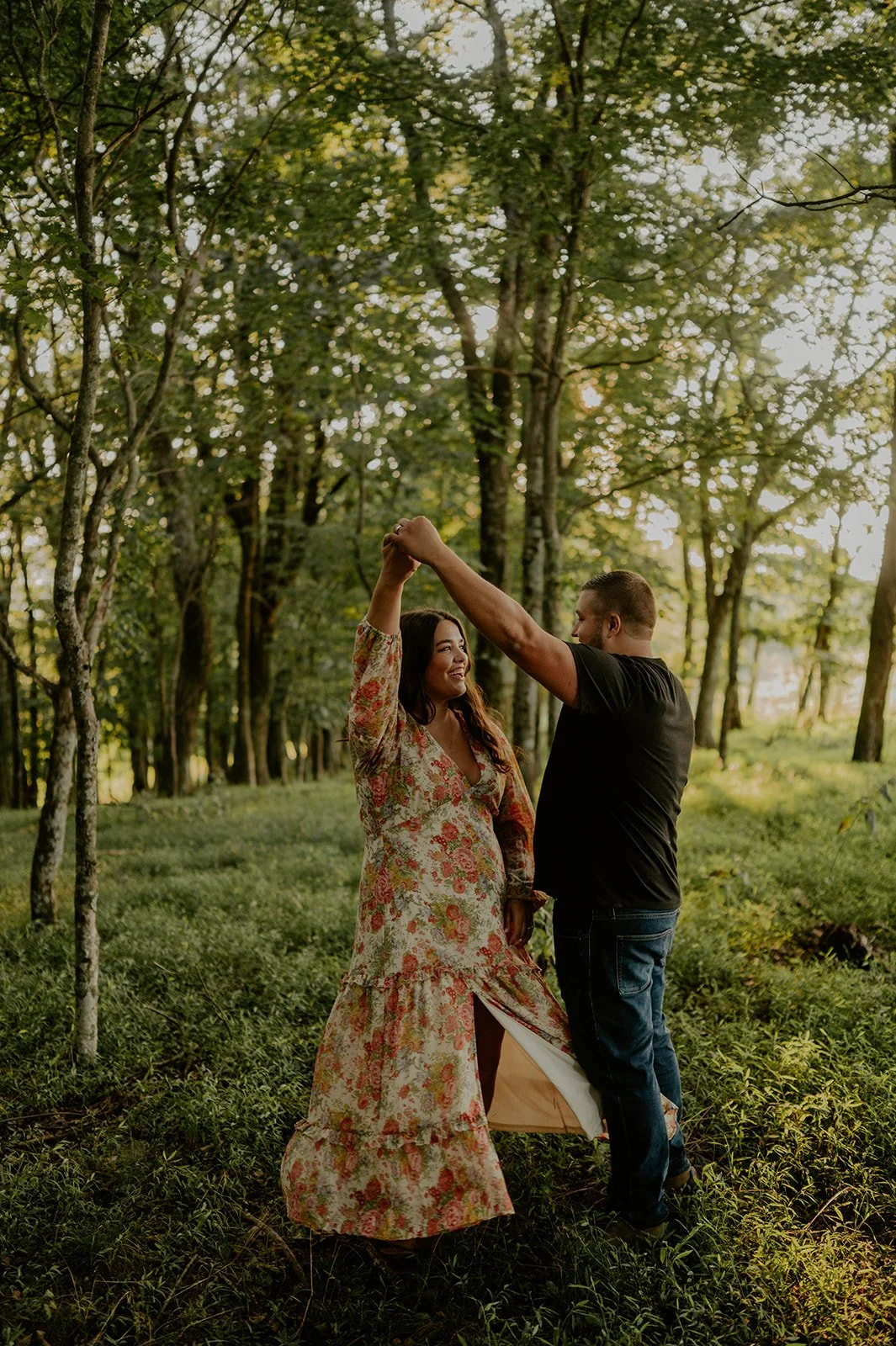 Couple dancing in the forest at golden hour