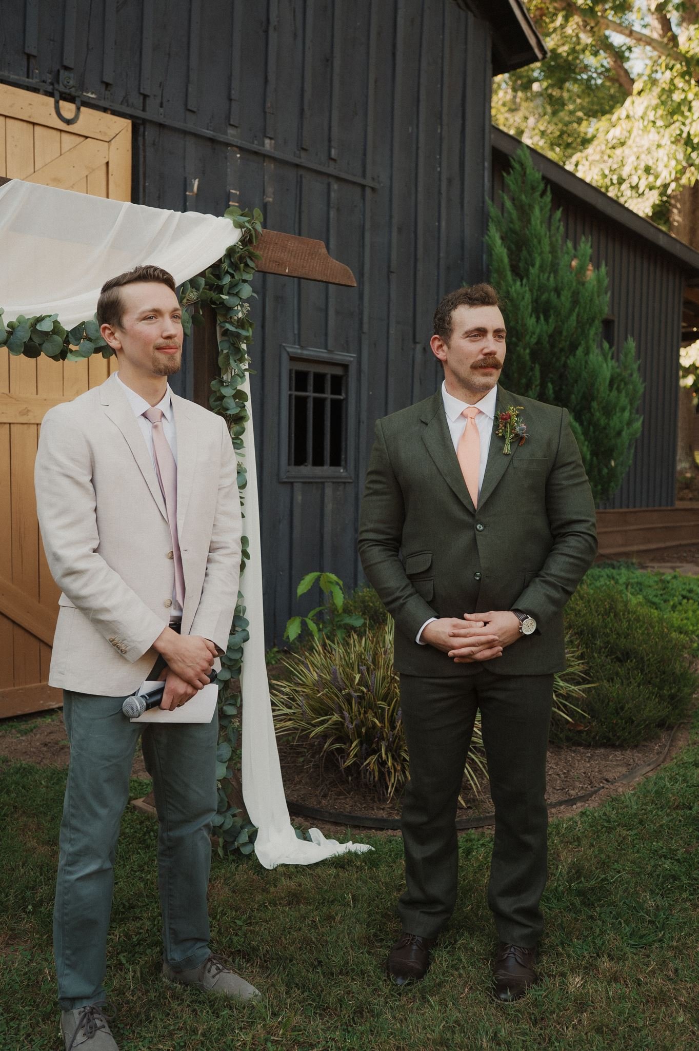 groom dipping bride in front of venue