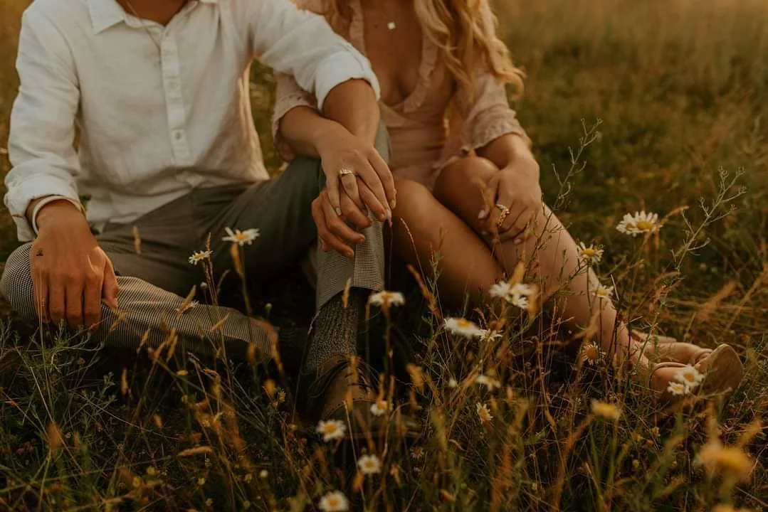 Close up of holding hands with engagement ring on