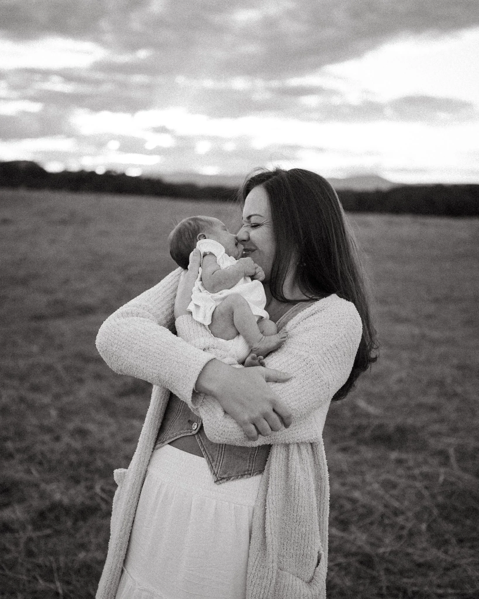 mom holding baby to her face