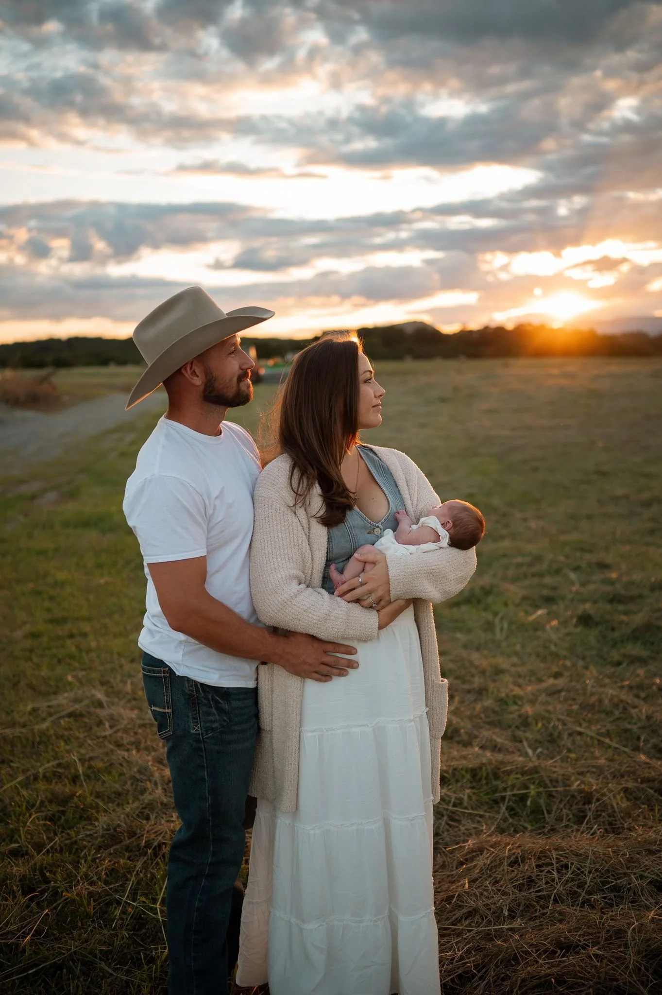 parents look into distance while holding newborn