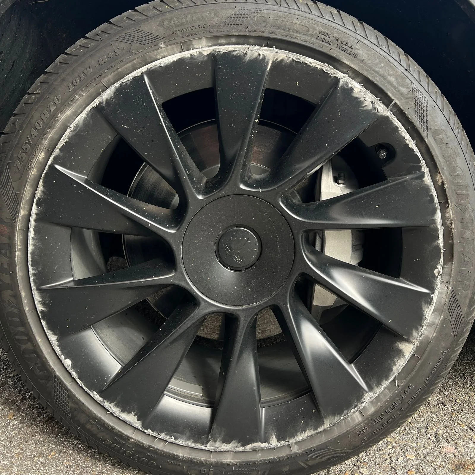 A Tesla wheel that has been damaged by really bad curb rash in Orange County, CA