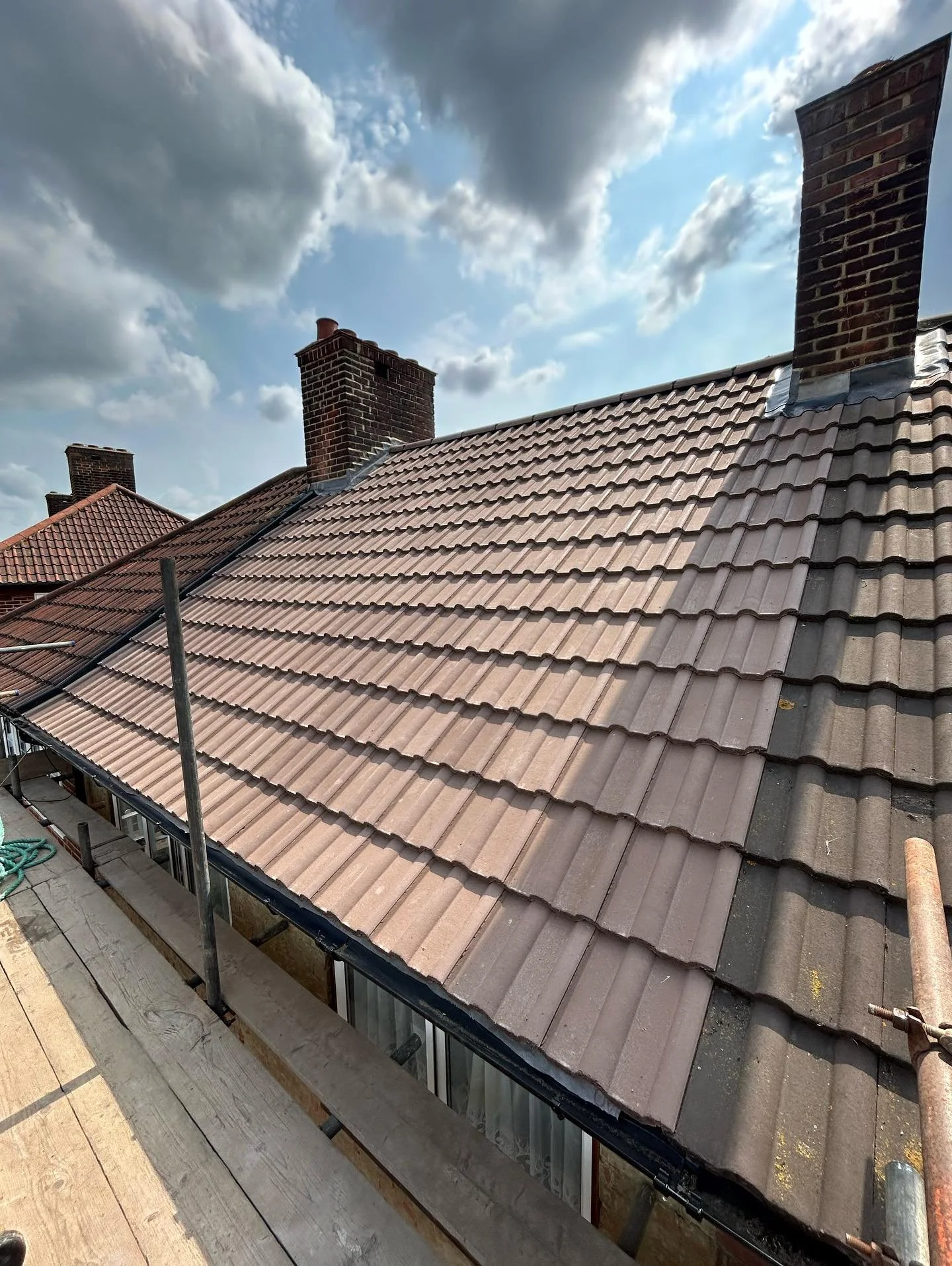 A Reroof we completed today on an up and over in Mottingham. We used Redland Tudor brown double roman concrete interlocking tiles with a vented dry ridge system , we also replaced fascia’s, soffits and guttering front and back with new plastic