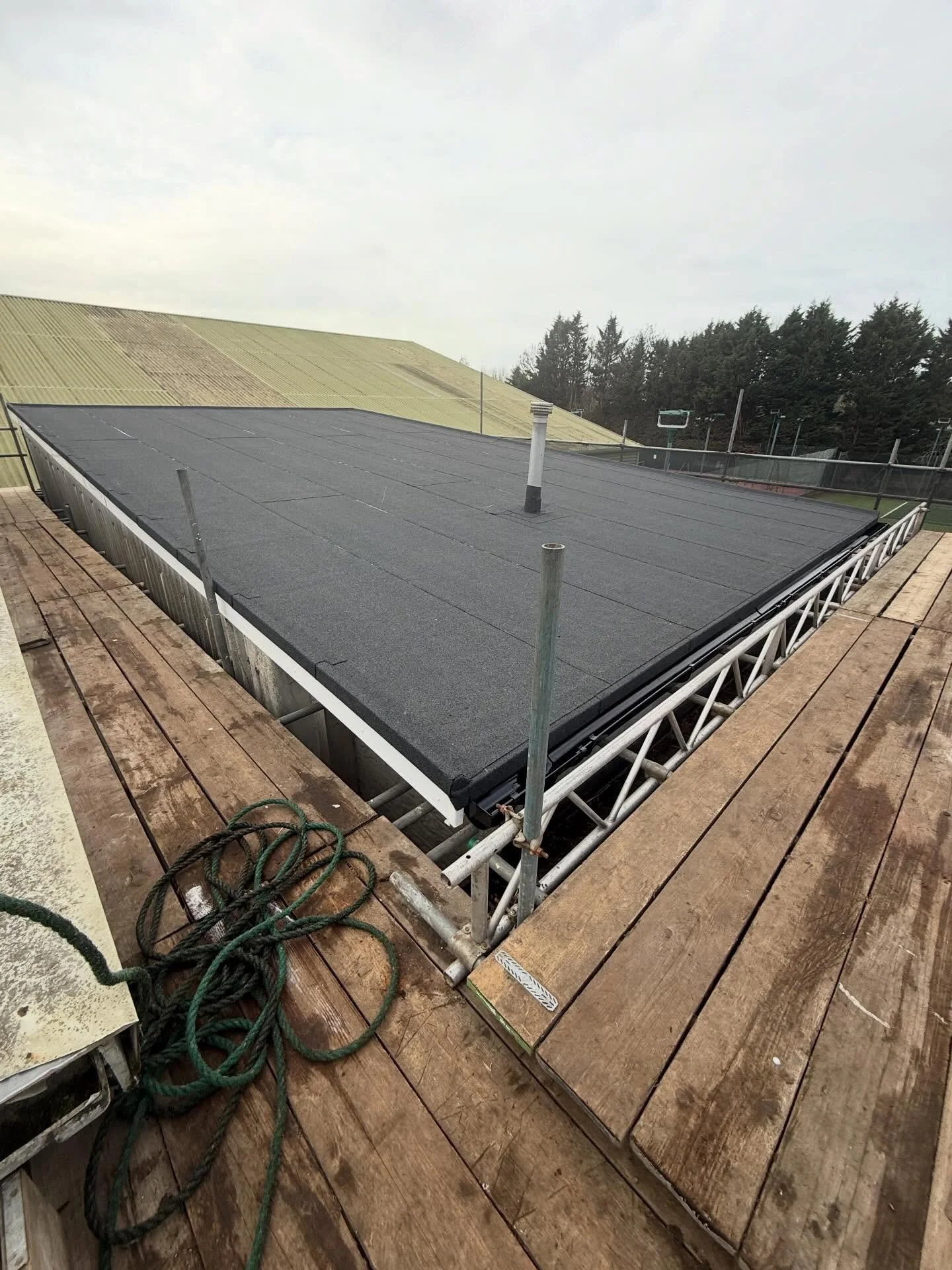 A flat roof we have recently completed at Bromley Lawn and Tennis Club. We removed all asbestos sheets , supplied and installed new timber joists with 18mm OSB we then applied a three layer torch on system with new white plastic fascia to all 4 sides