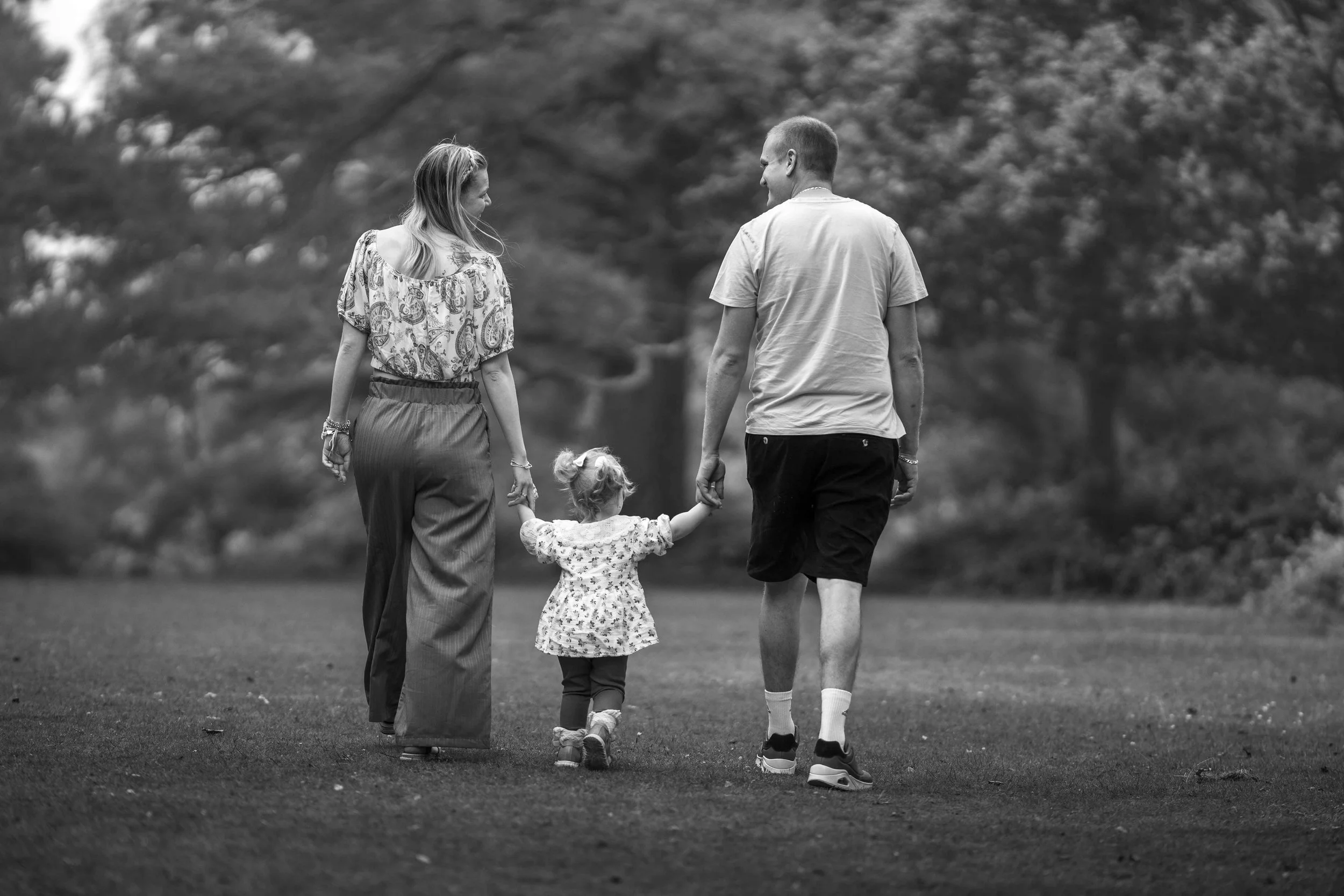 parents on a walk with their little daughter 