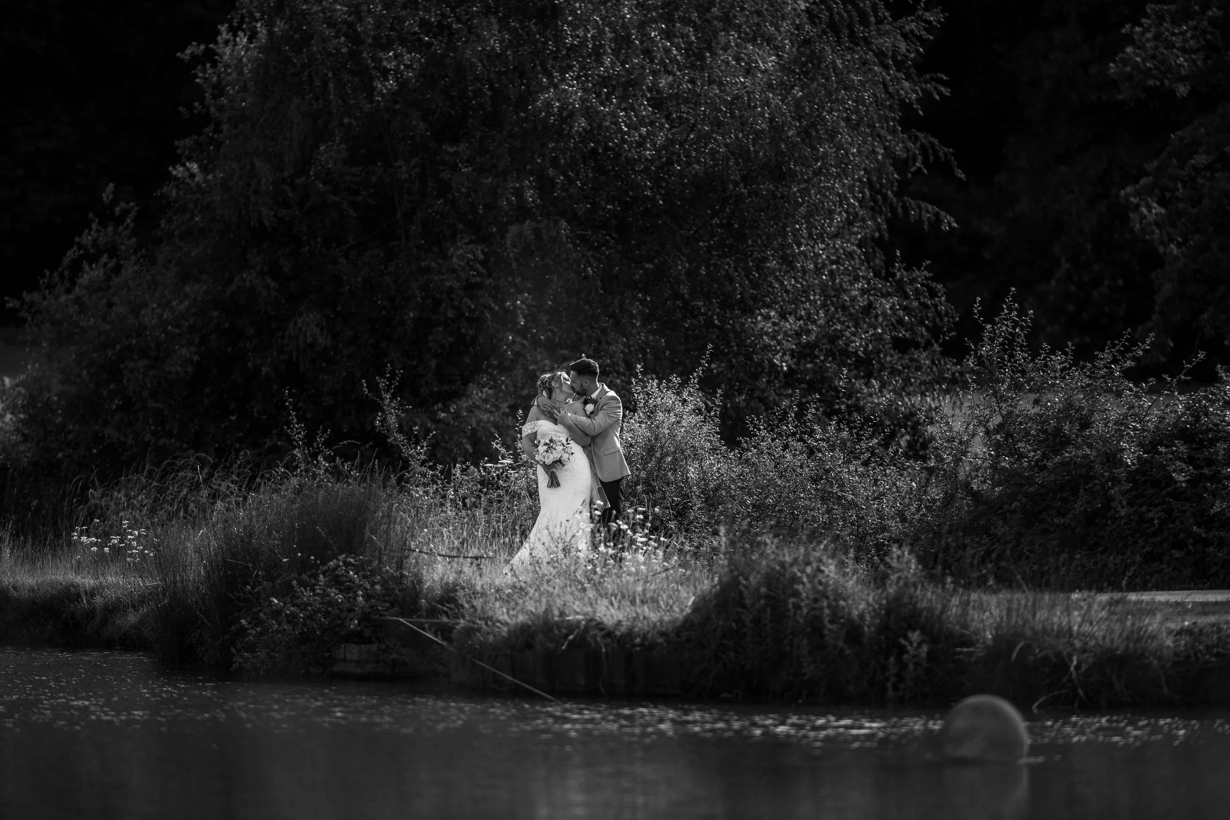 dramatic black and white photo of bride and groom hugging.jpg