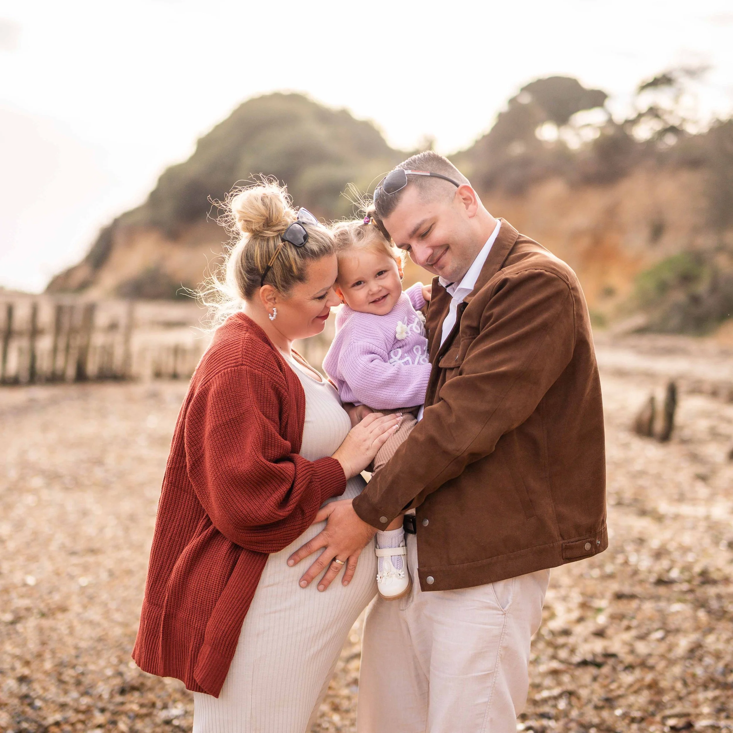 pregnancy session on the beach with lovely smiley family