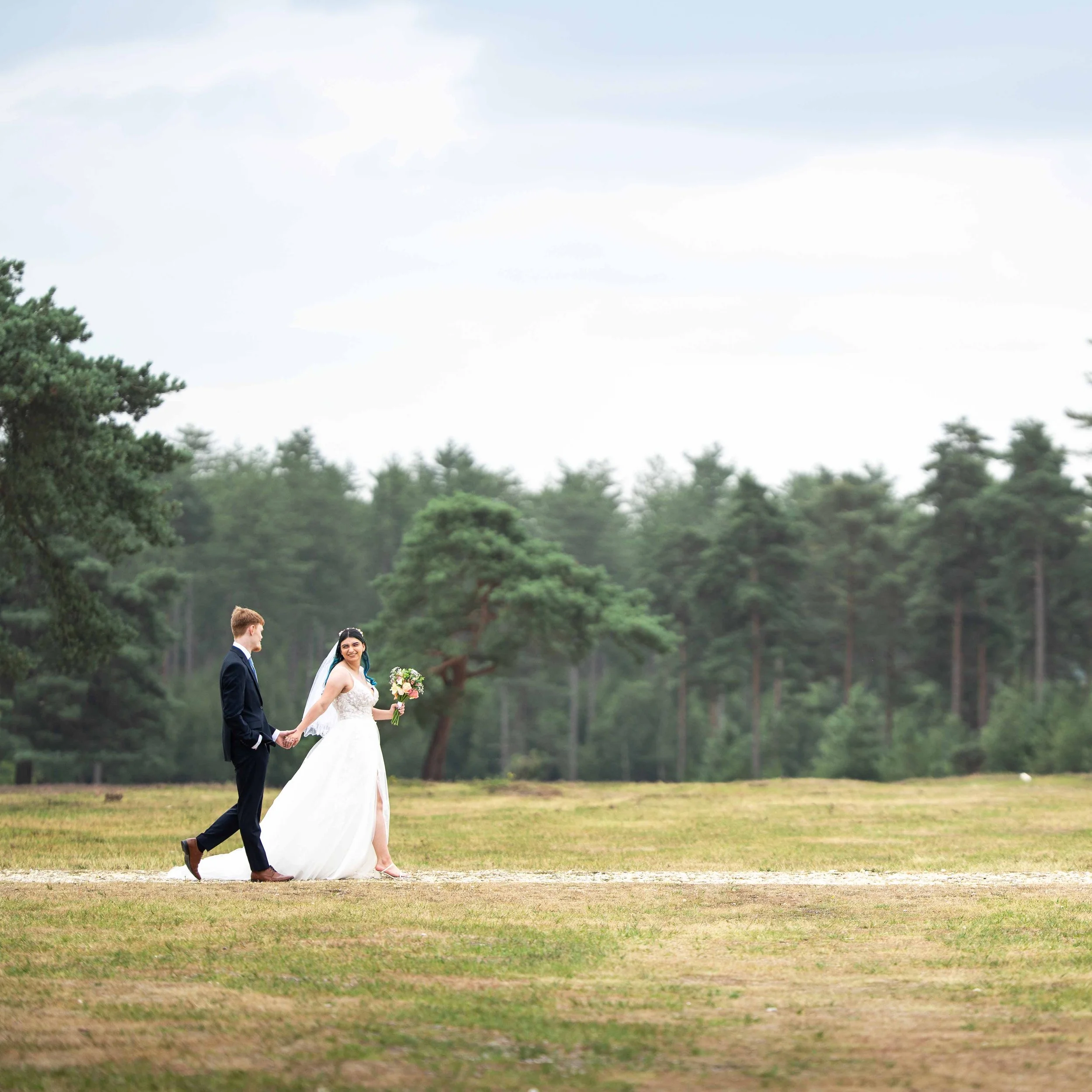 bride and groom candid photograph as they walk through new forest