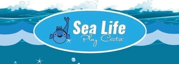 Sea Life Play Centre logo featuring a smiling fish with a crown, waves in the background, and the text 'Sea Life Play Centre'.