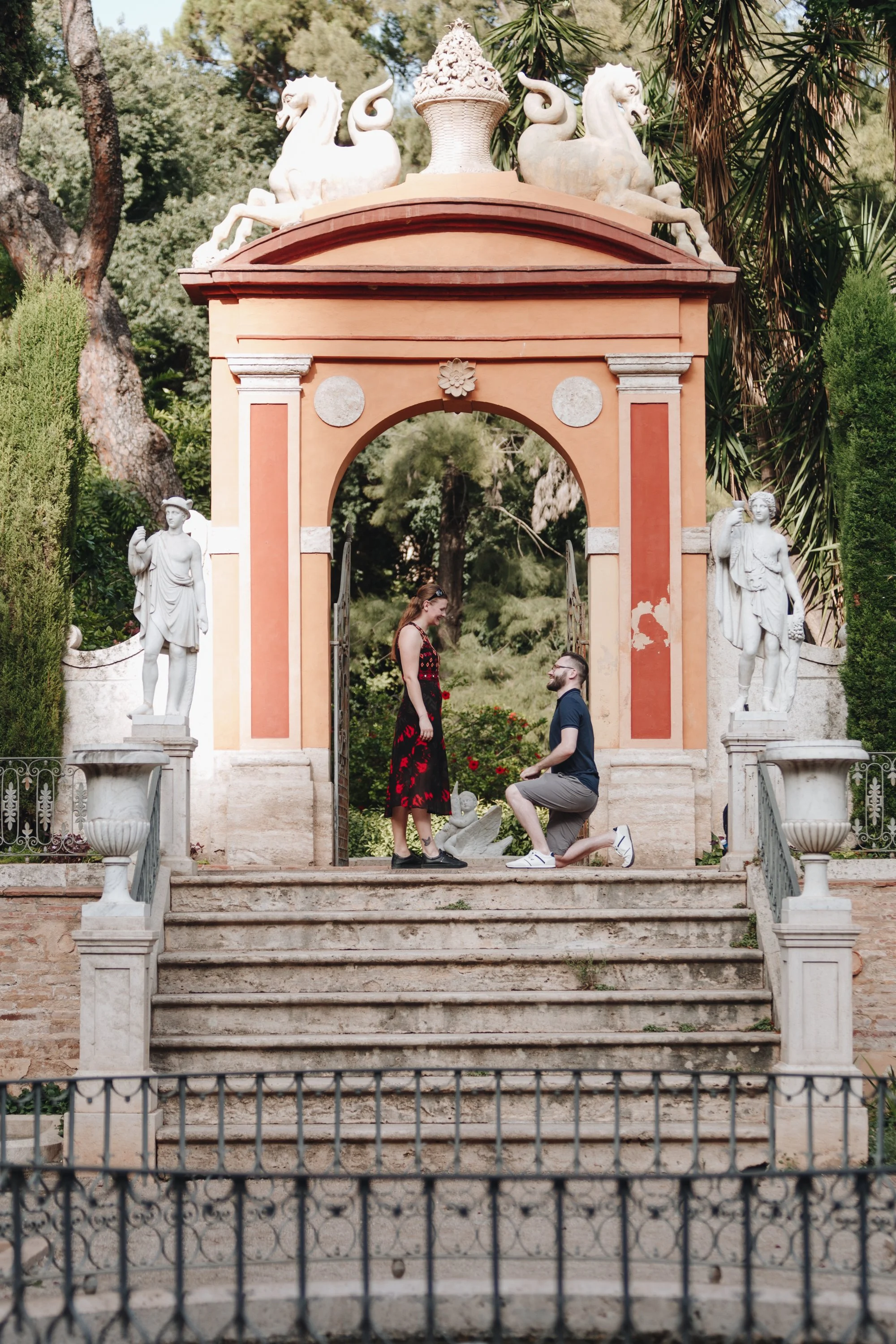 Marriage proposal moment, groom kneeling in front of the bride.