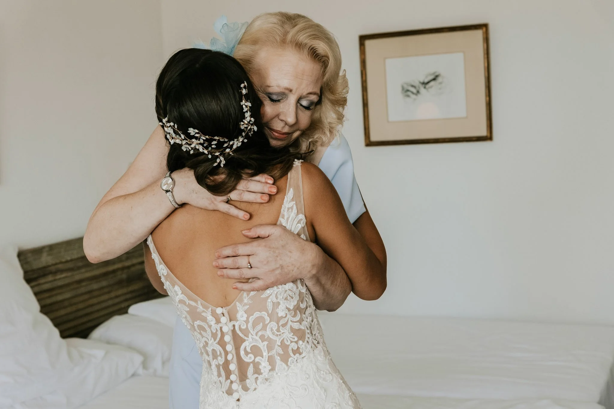 candid-portrait-of-bride-and-mom-hug-Masía-casa-del-mar-barcelona-destination-wedding-photographer.jpg