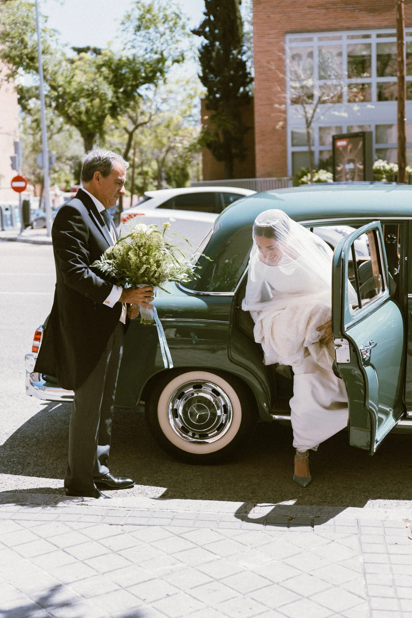 editorial-portrait-of-bride-in-wedding-luxury-car-film-photography-La-Baronia-barcelona-destination-wedding-photographer.jpg