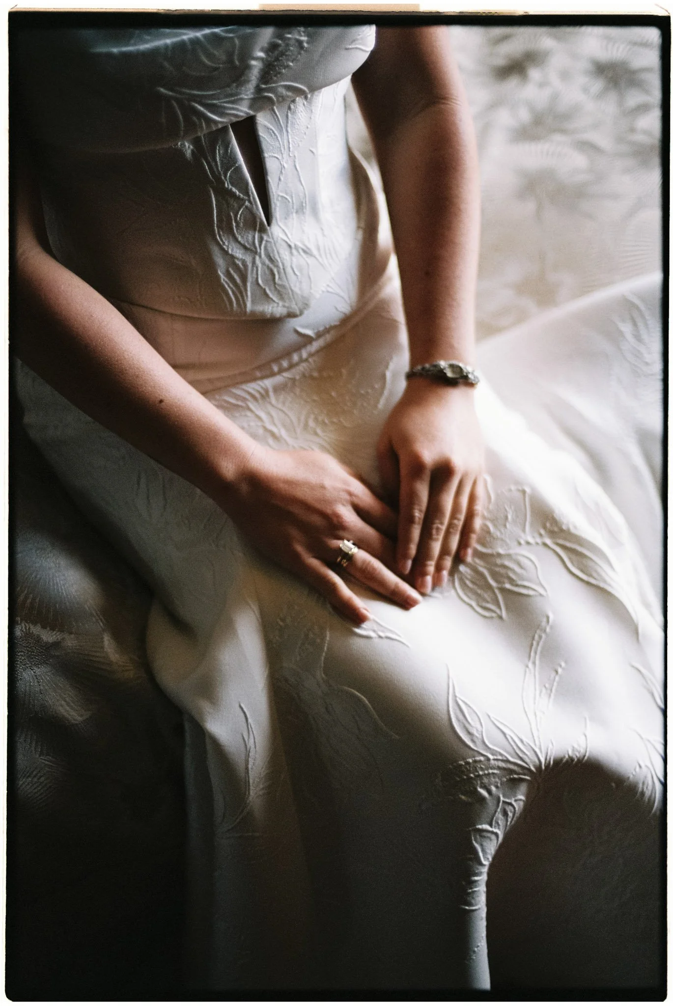 Film detail photo of brides hands with the engagement ring and her mom's luxury watch.