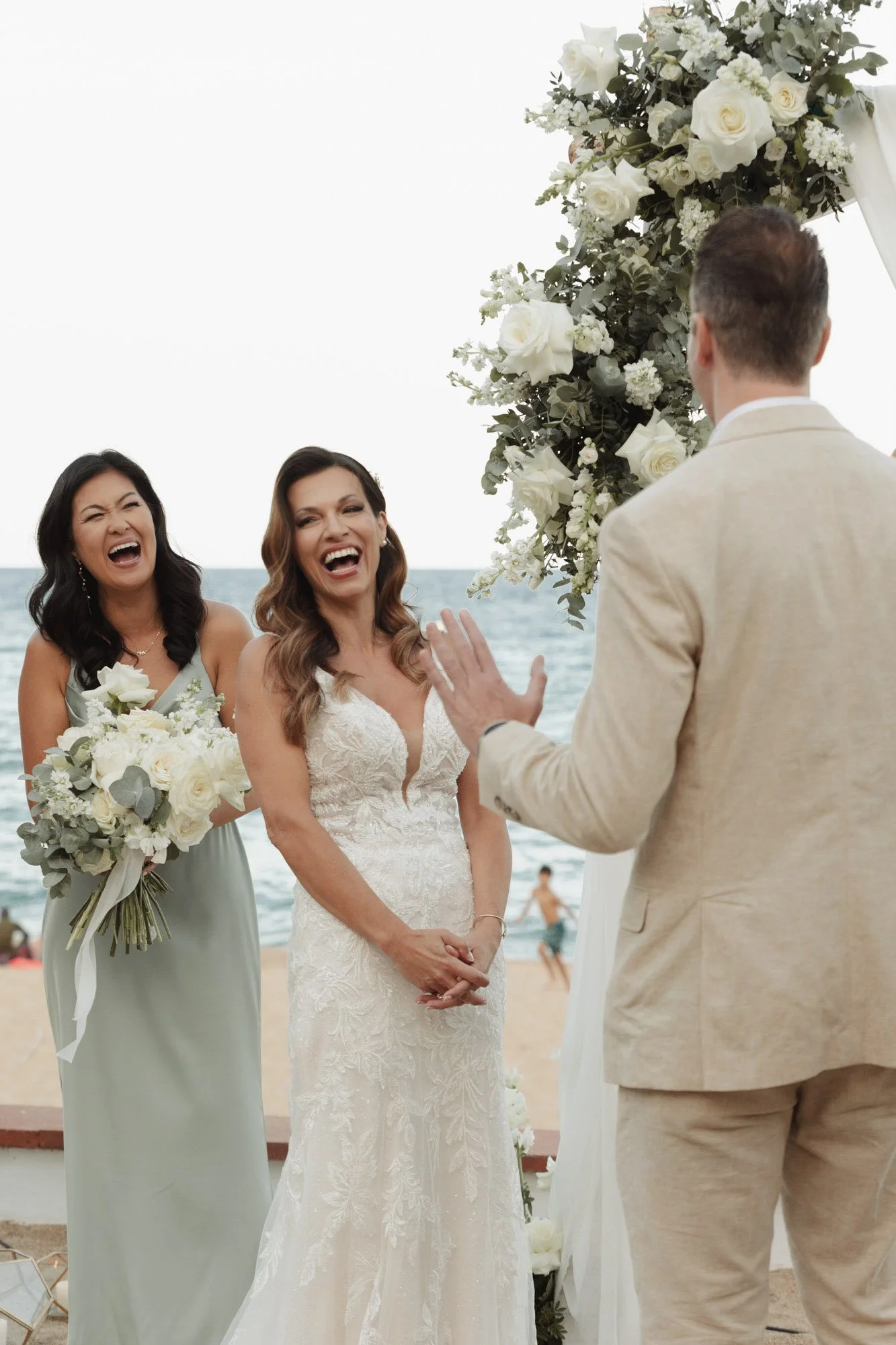 candid-portrait-of-bride-and-bridesmaid-laughing-at-ceremony-mas-terrats-barcelona-destination-wedding-photographer .jpg