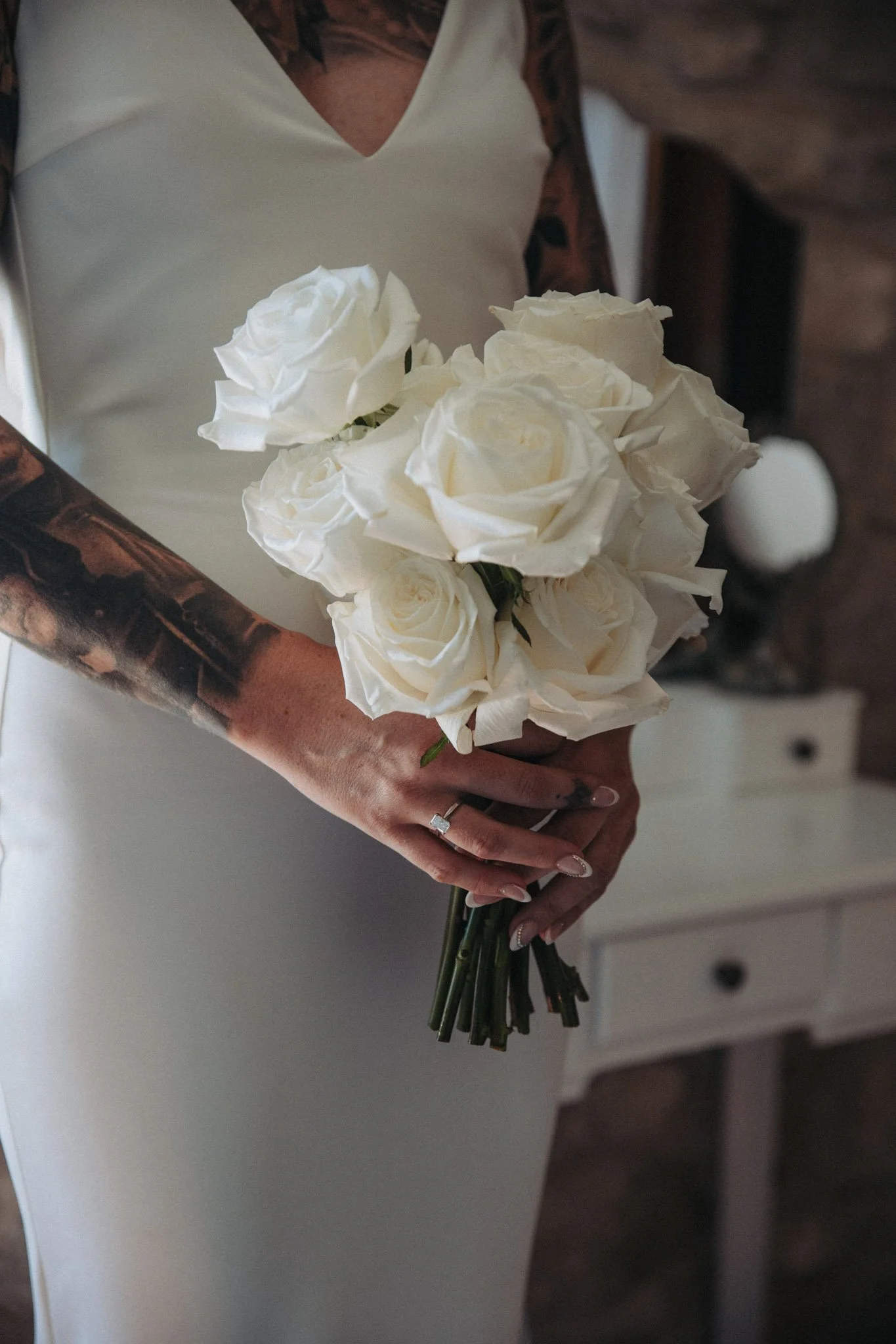 bride-holding-white-roses-bouquet-detail-peralada-castle-girona-destination-wedding-photographer.jpg