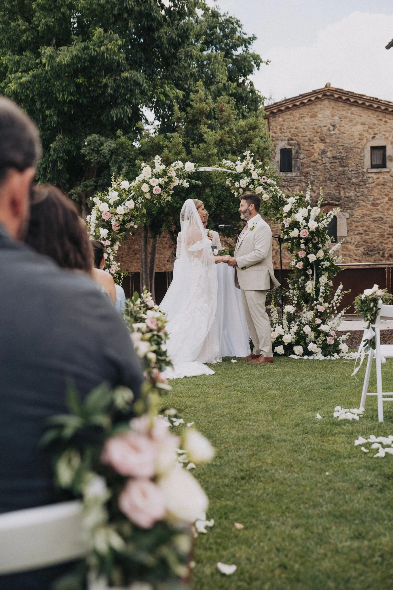 candid-photo-of-bride-and-groom-holding-hands-at-ceremony-finca-torre-bosch-alicante-costa-blanca-destination-wedding-photographer.jpg