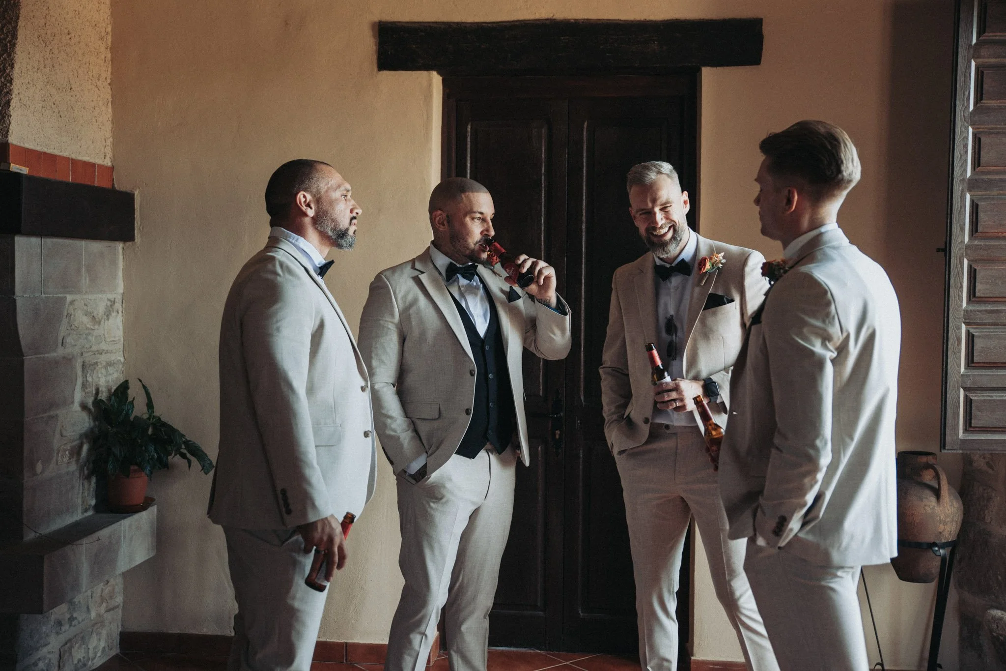 groom-and-bestmen-portrait-toasting-tamarit-castle-barcelona-destination-wedding-photographer.jpg
