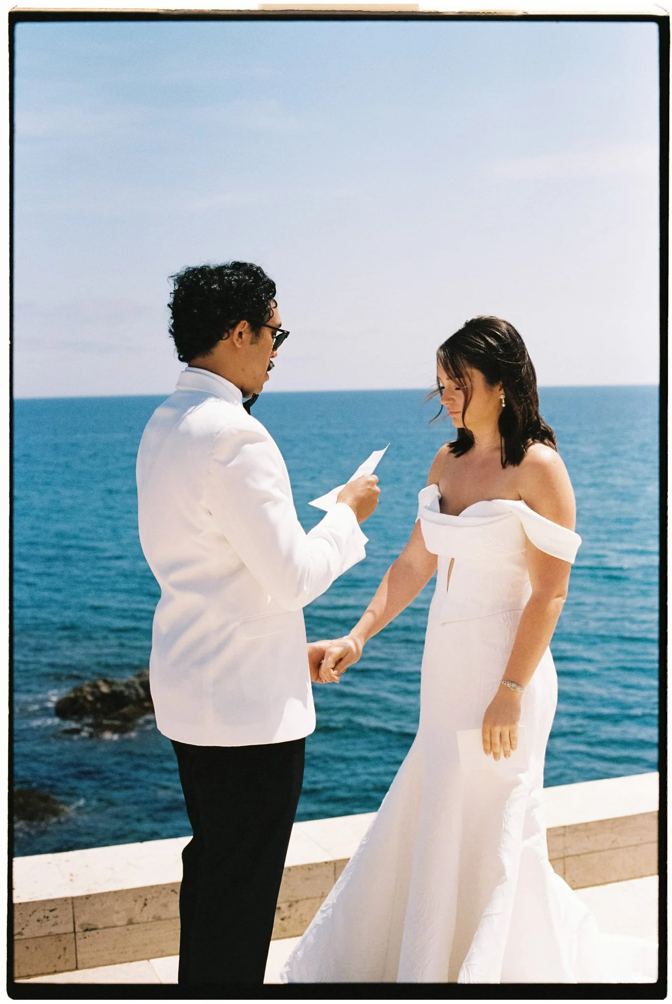 Couple reading their vows in front of the sea in La Costa Brava