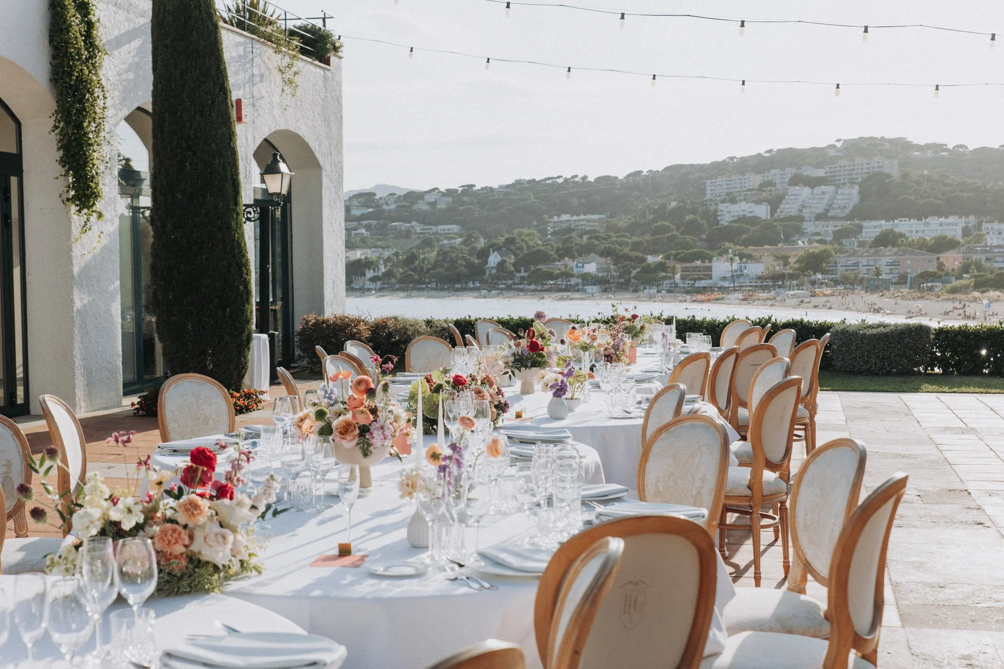 dinner-tables-under-mediterranenan-light-with-flower-decor-casa-santonja-valencia-destination-wedding-photographer.jpg
