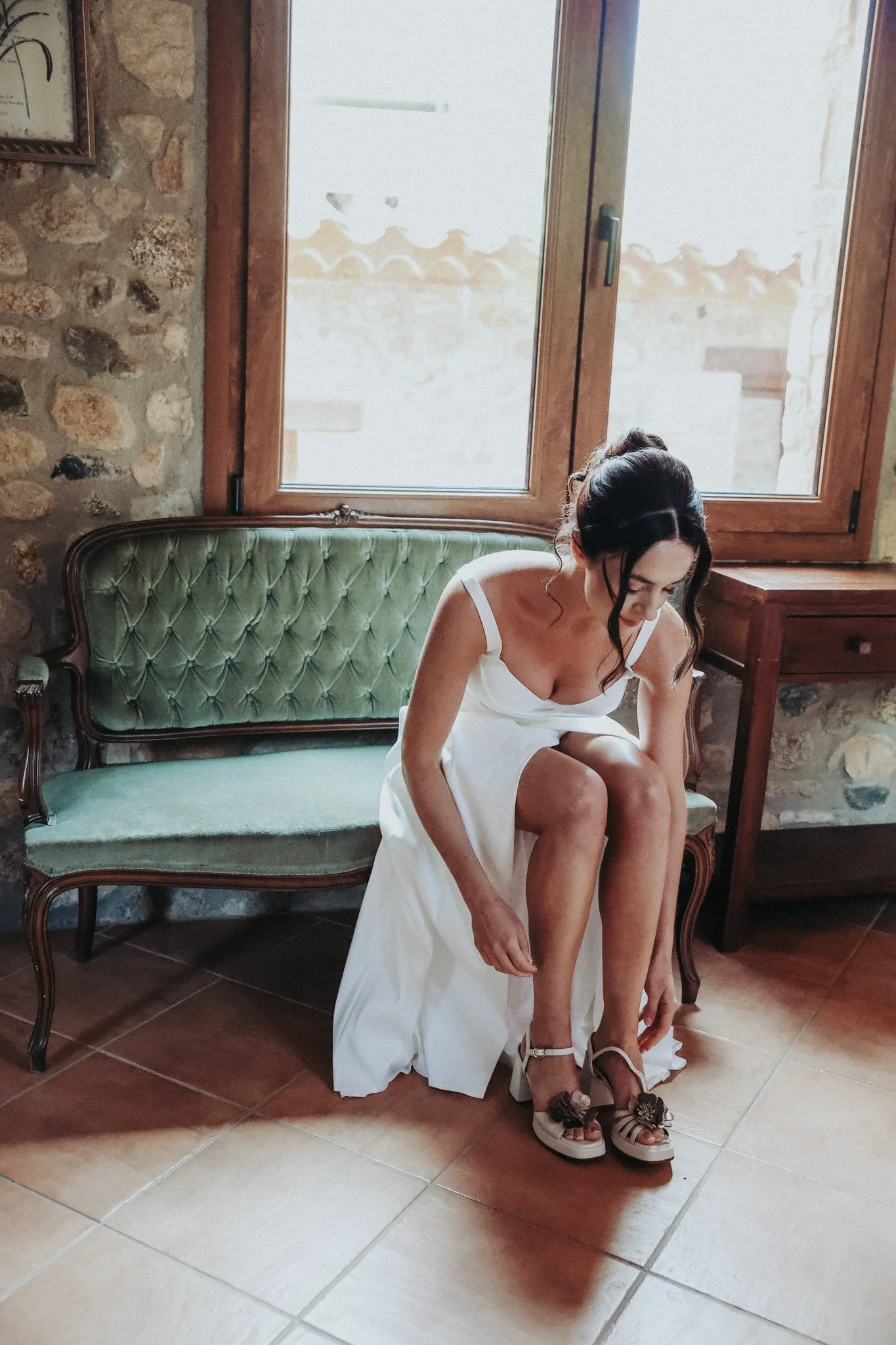 editorial-portrait-of-bride-putting-shoes-on-in-film-35mm-portra-la-gavina-girona-destination-wedding-photographer.jpg