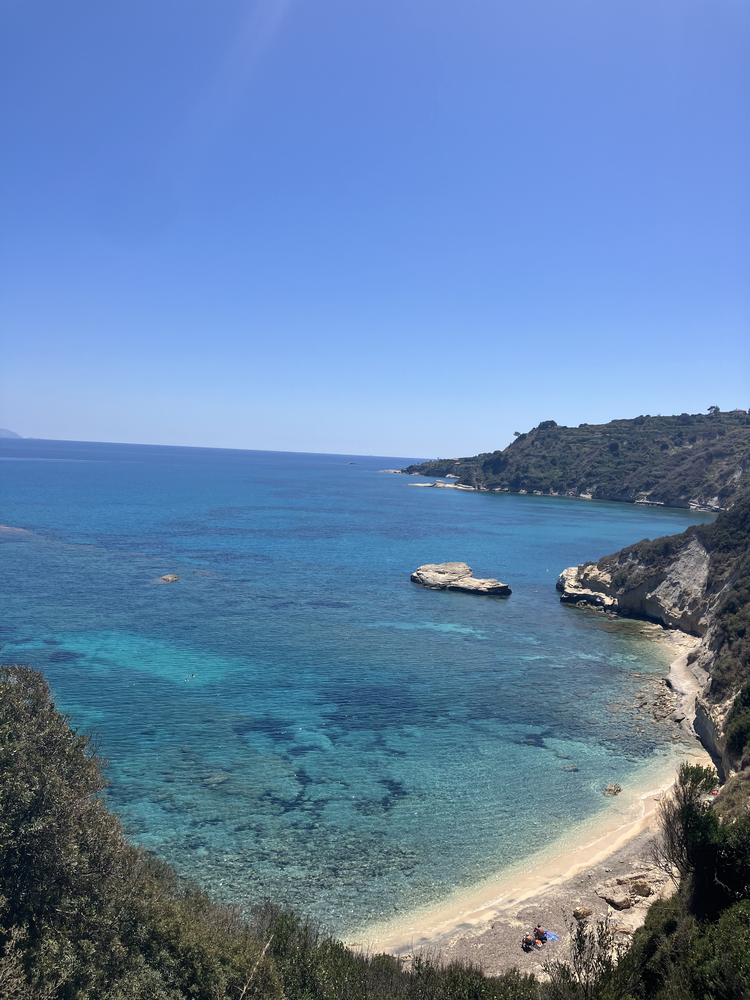 One of the beaches near the retreat centre, with clear sea and hills surrounding it