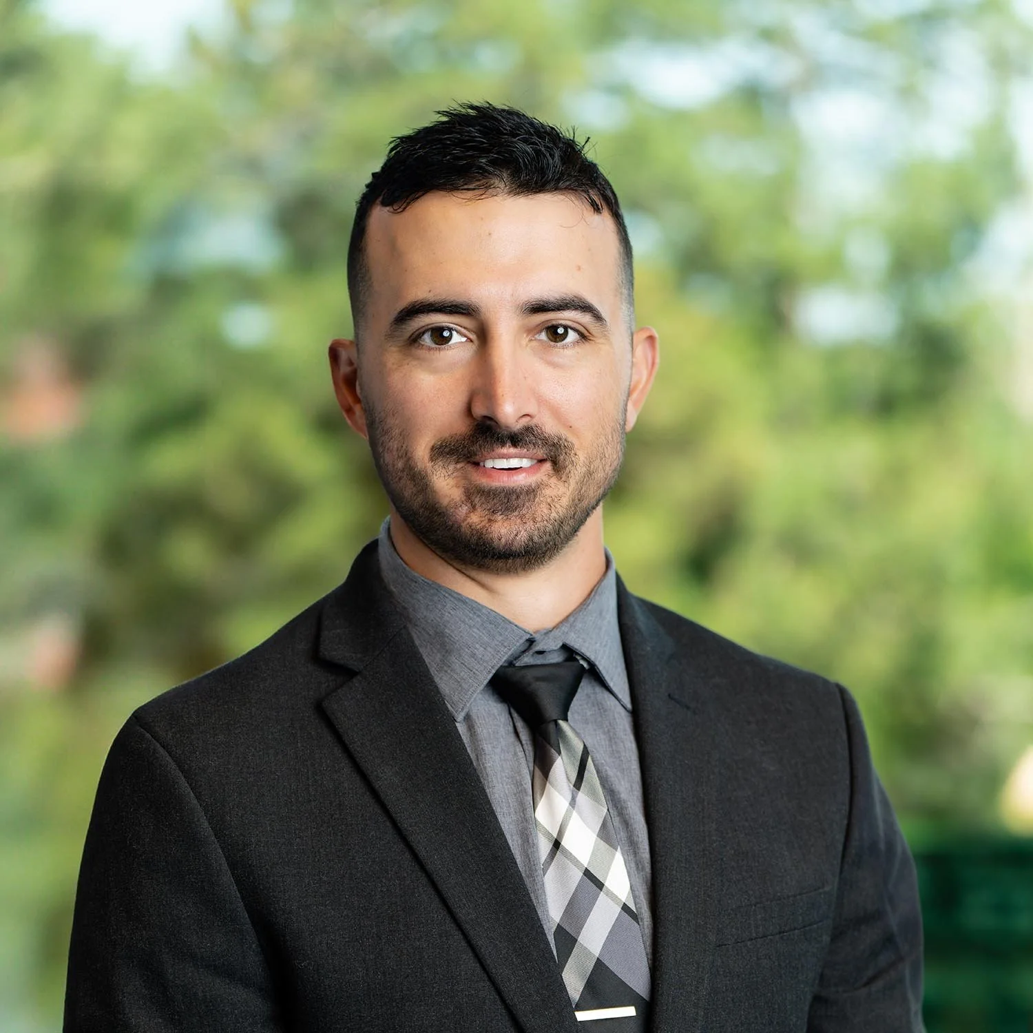 Dave Riedel with dark suit and gray shirt and tie