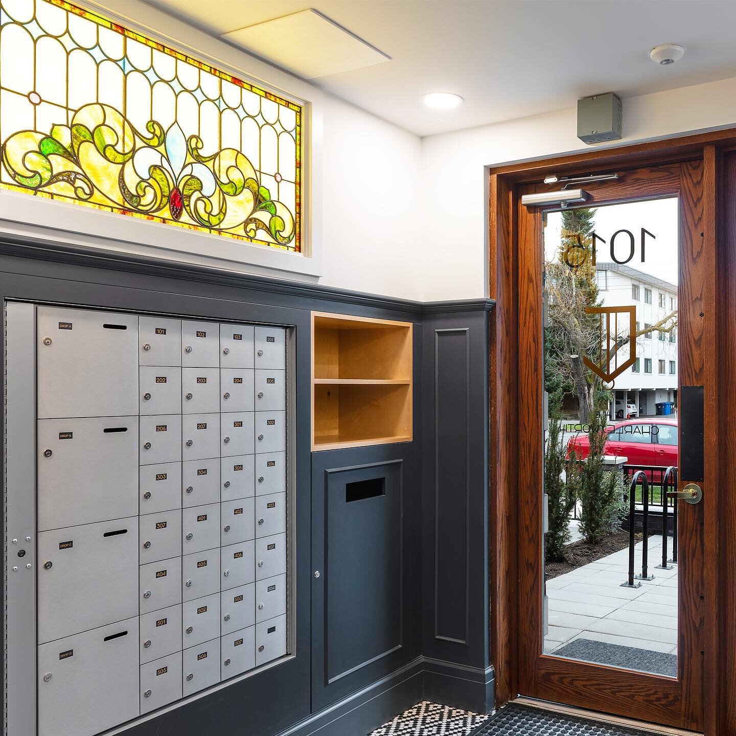 Entry vestibule at The Charlesworth - the backlit stained glass feature was salvaged and restored from the unbuilt structure (@unbuildersdeconstruction ) that previously existed on this Cook Street site.