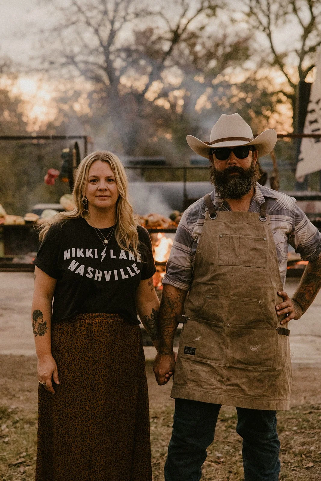 Vanessa and Mike Torres of Gold Epicure beside their live-fire cooking setup