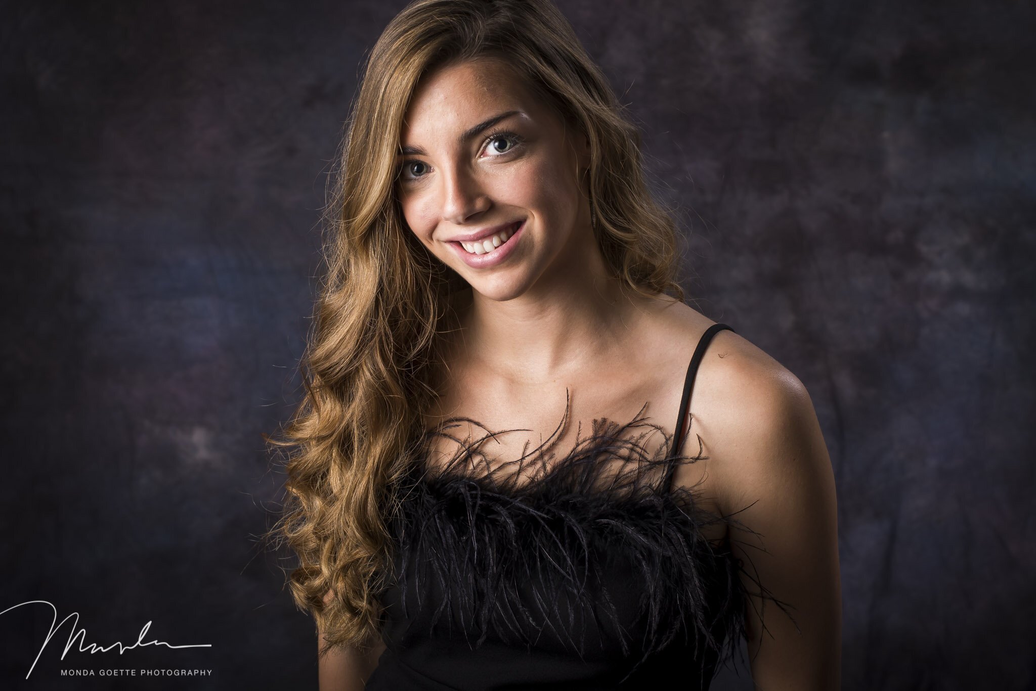 Senior girl with long curly hair during photo session at Monda Goette Photography in MN.