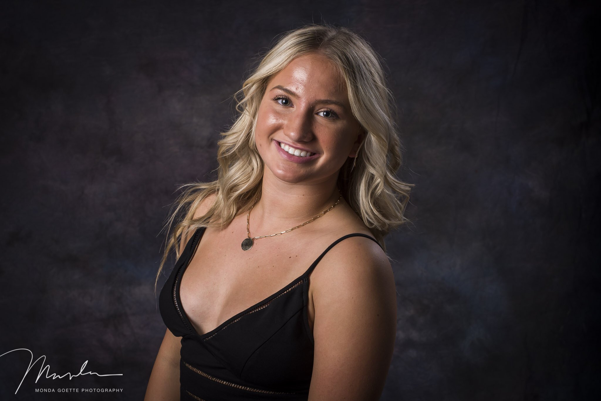senior girl smiling during high school photo session with Monda Goette Photography