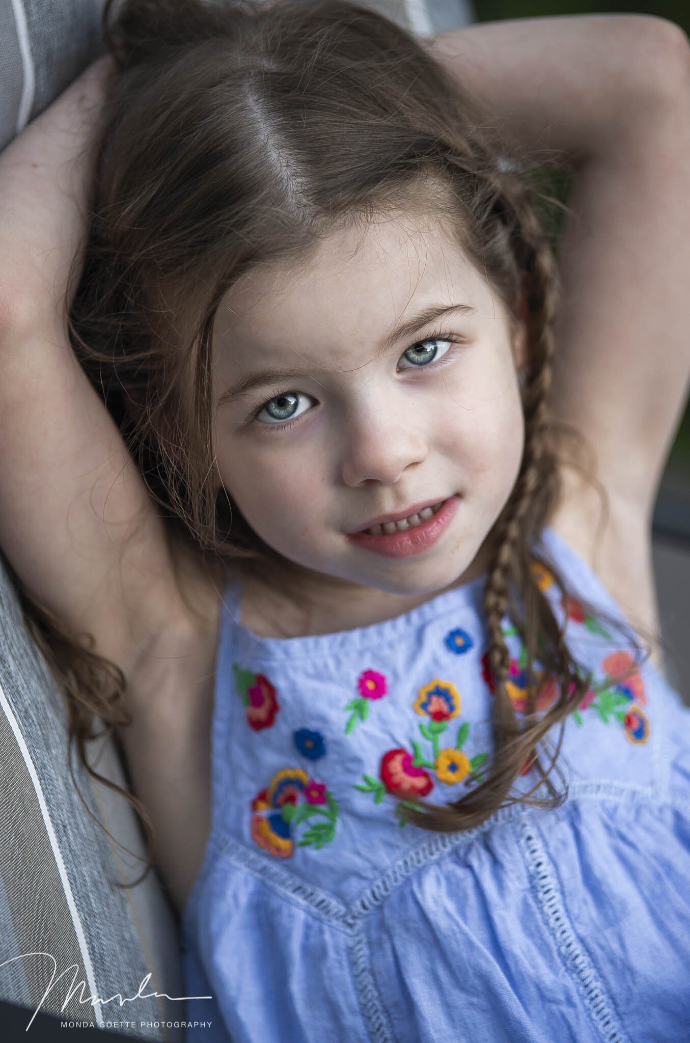 Little girl with her arms up during children's photo shoot at Monda Goette Photography.