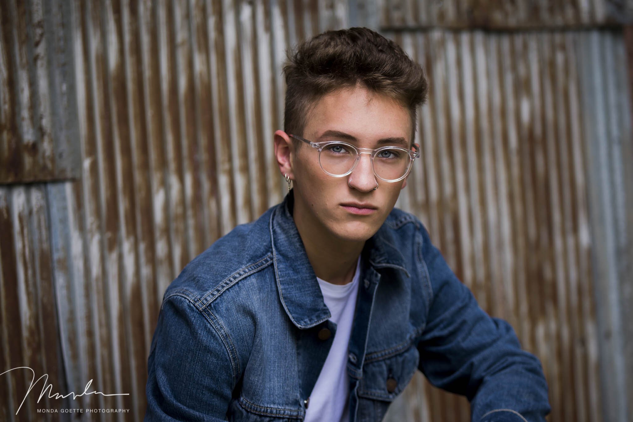 rustic tin background with senior boy serious face at Twin Cities photo studio