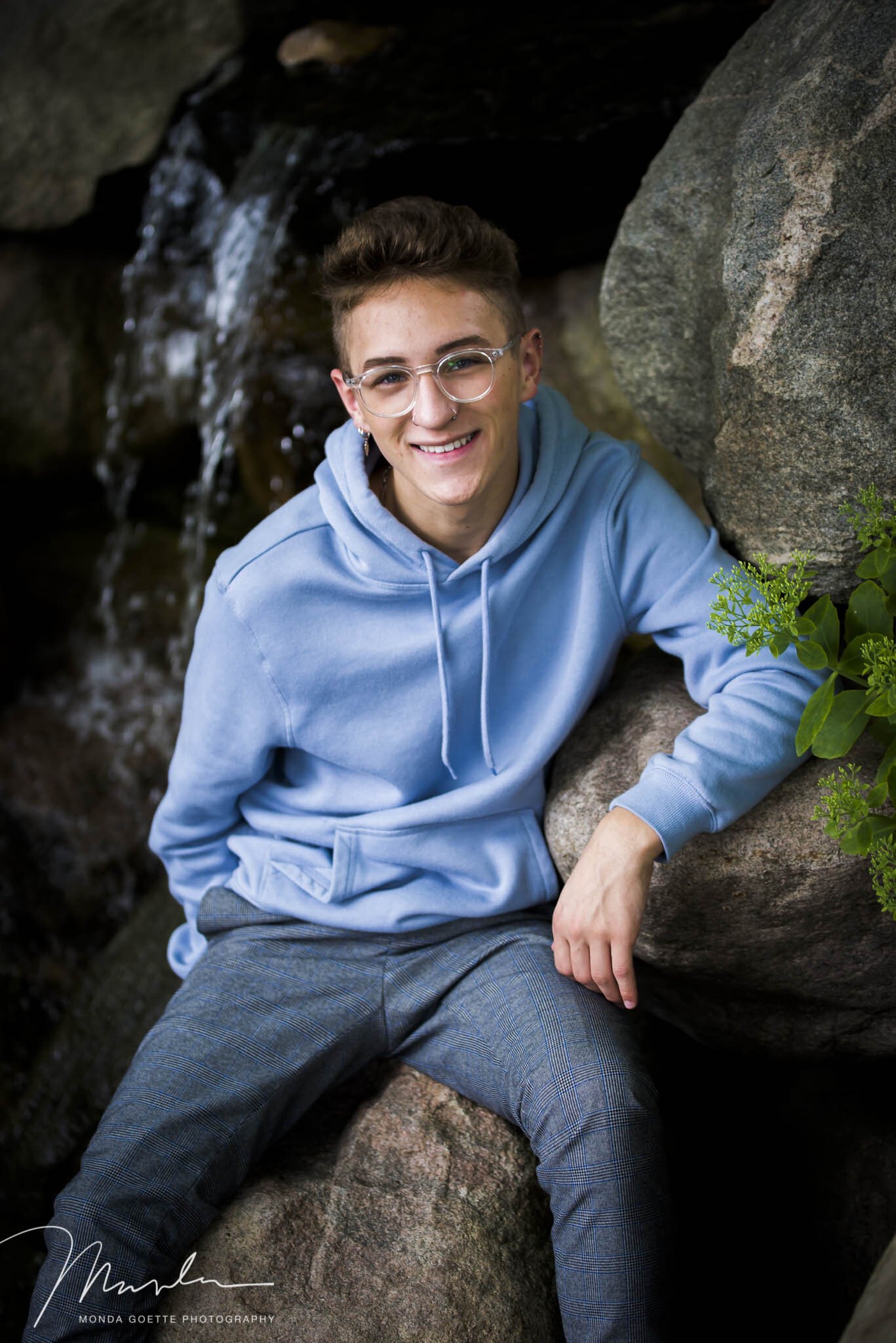 Hoodie and dress pants featured for senior guy session in South St. Paul MN photo studio