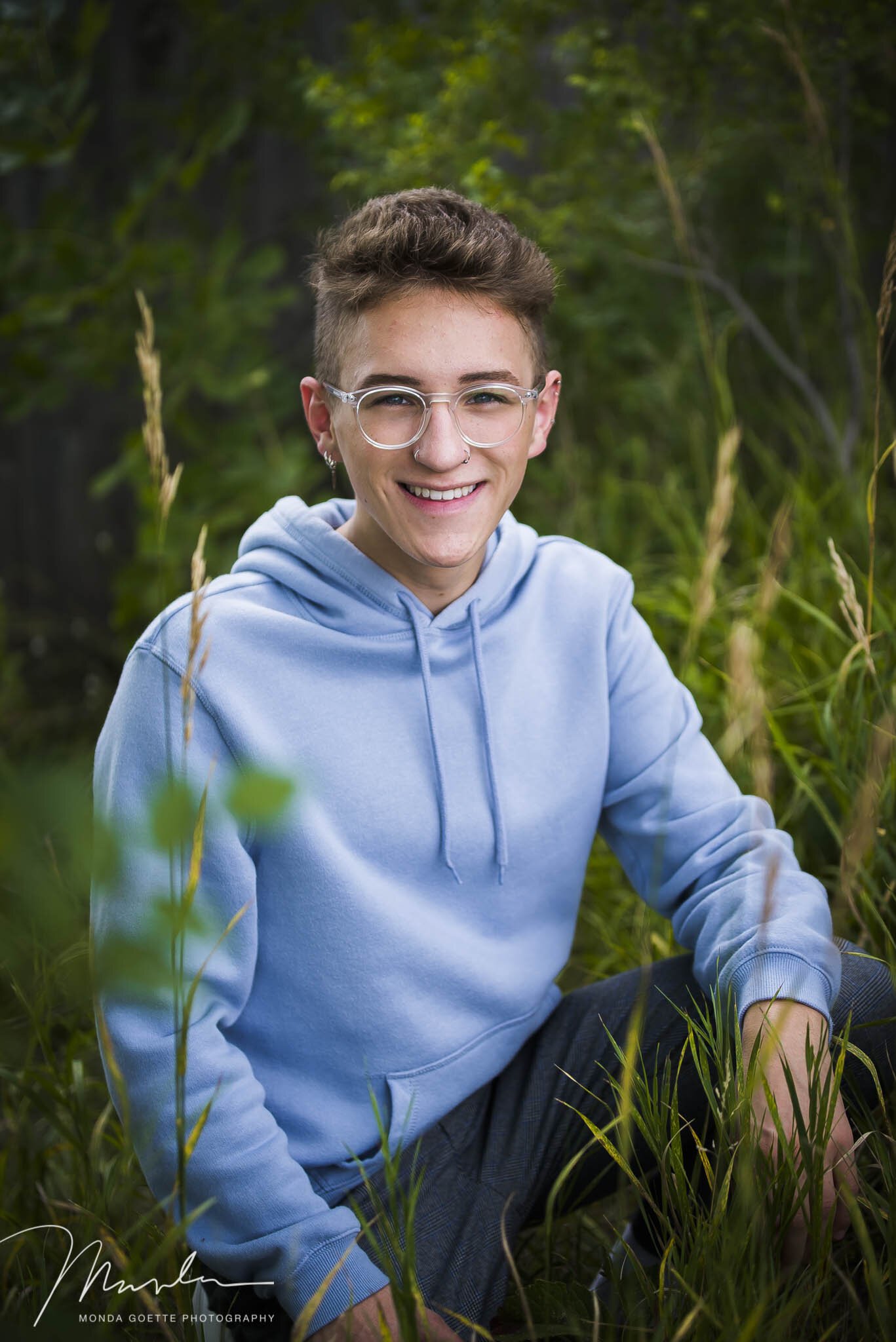 Tall grasses with senior guy smiling during photo session in MN
