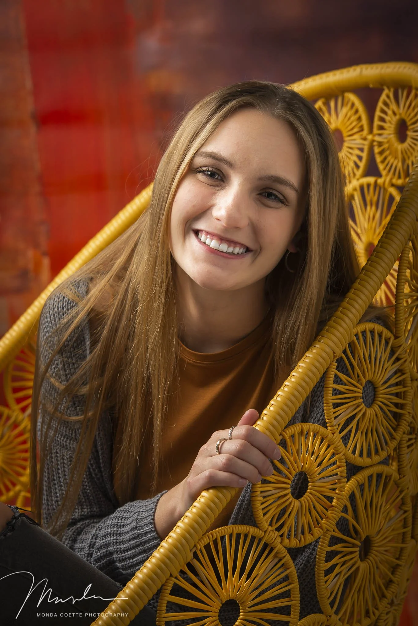Senior girl on yellow chair in South St. Paul studio