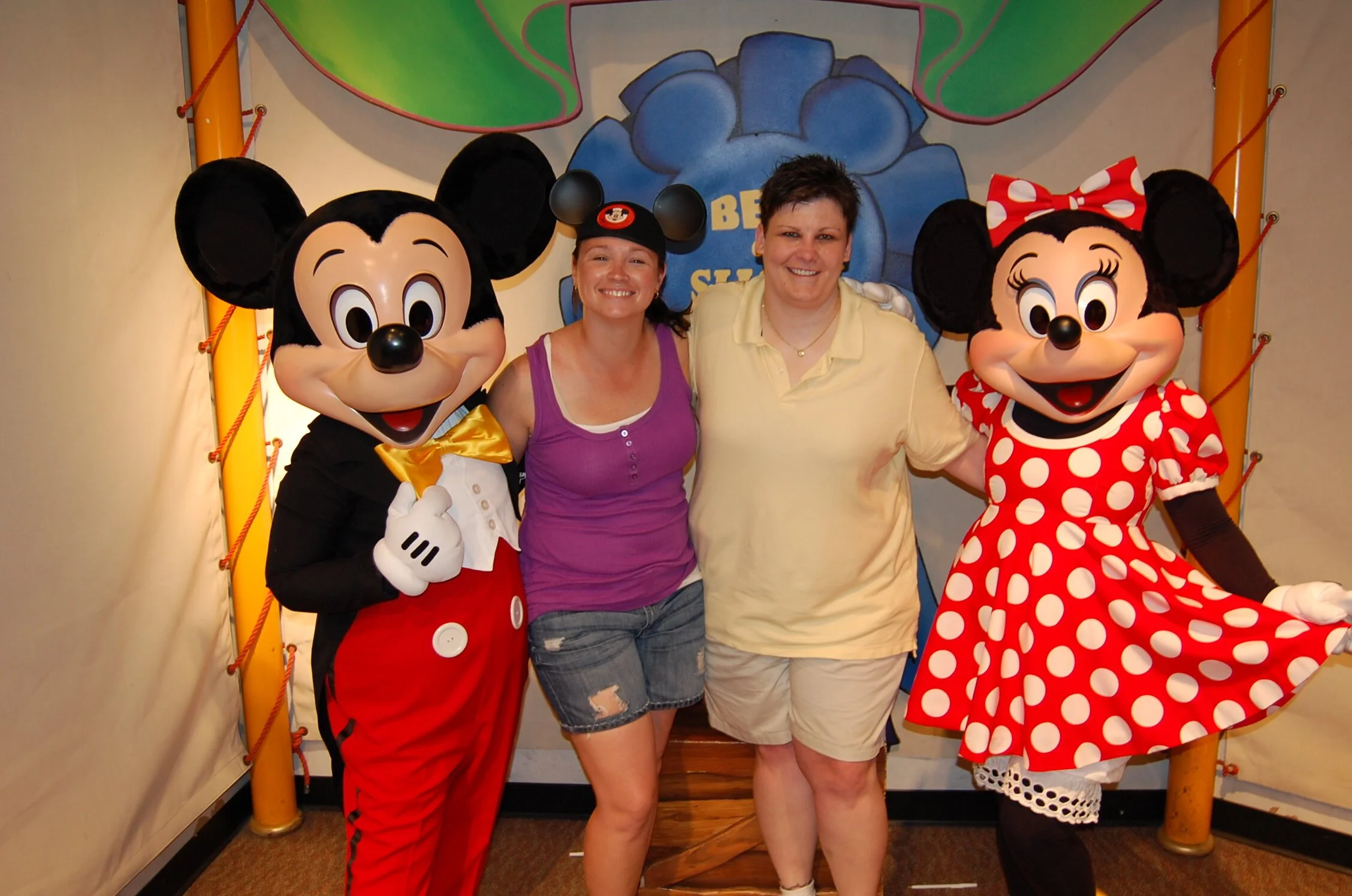 Best friends posing with Mickey and Minnie Mouse in Disney World, Florida.