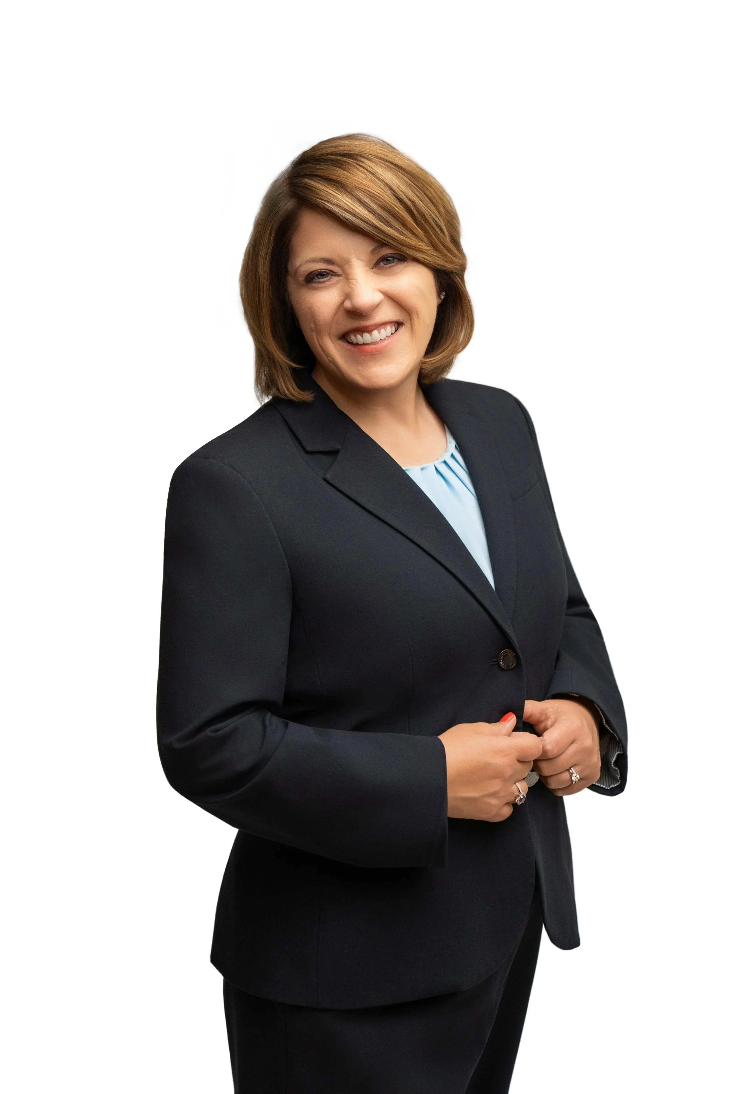 Female in a suit posing for a portrait 2/4 length on a bright white backdrop for a personal branding photo session.