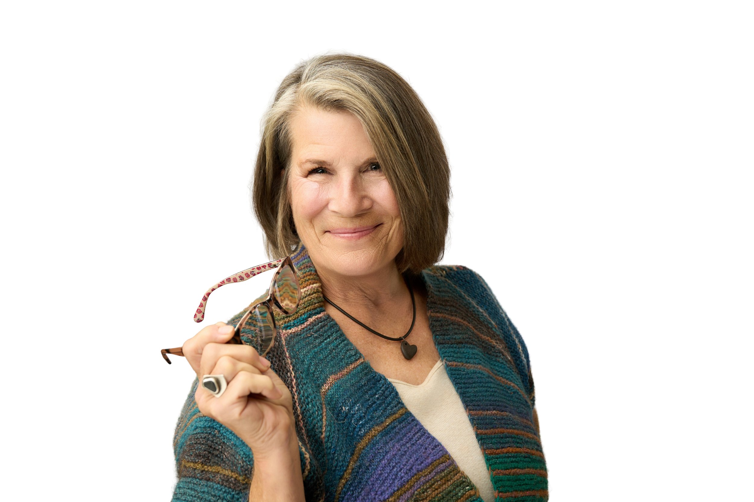 Woman holding glasses for a branding portrait on a bright white background.