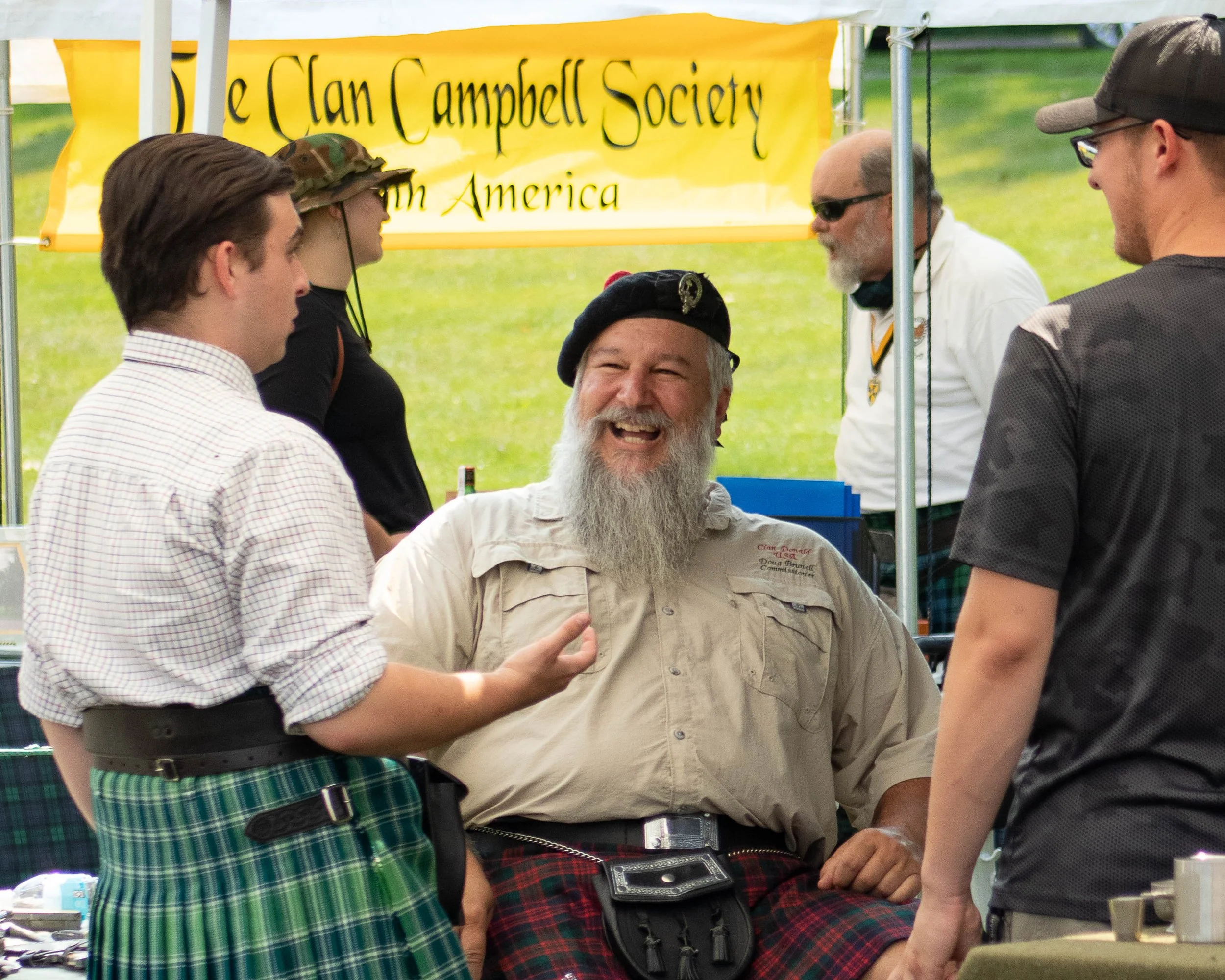 Men in kilts laughing during the Kalamazoo Scottish Festival